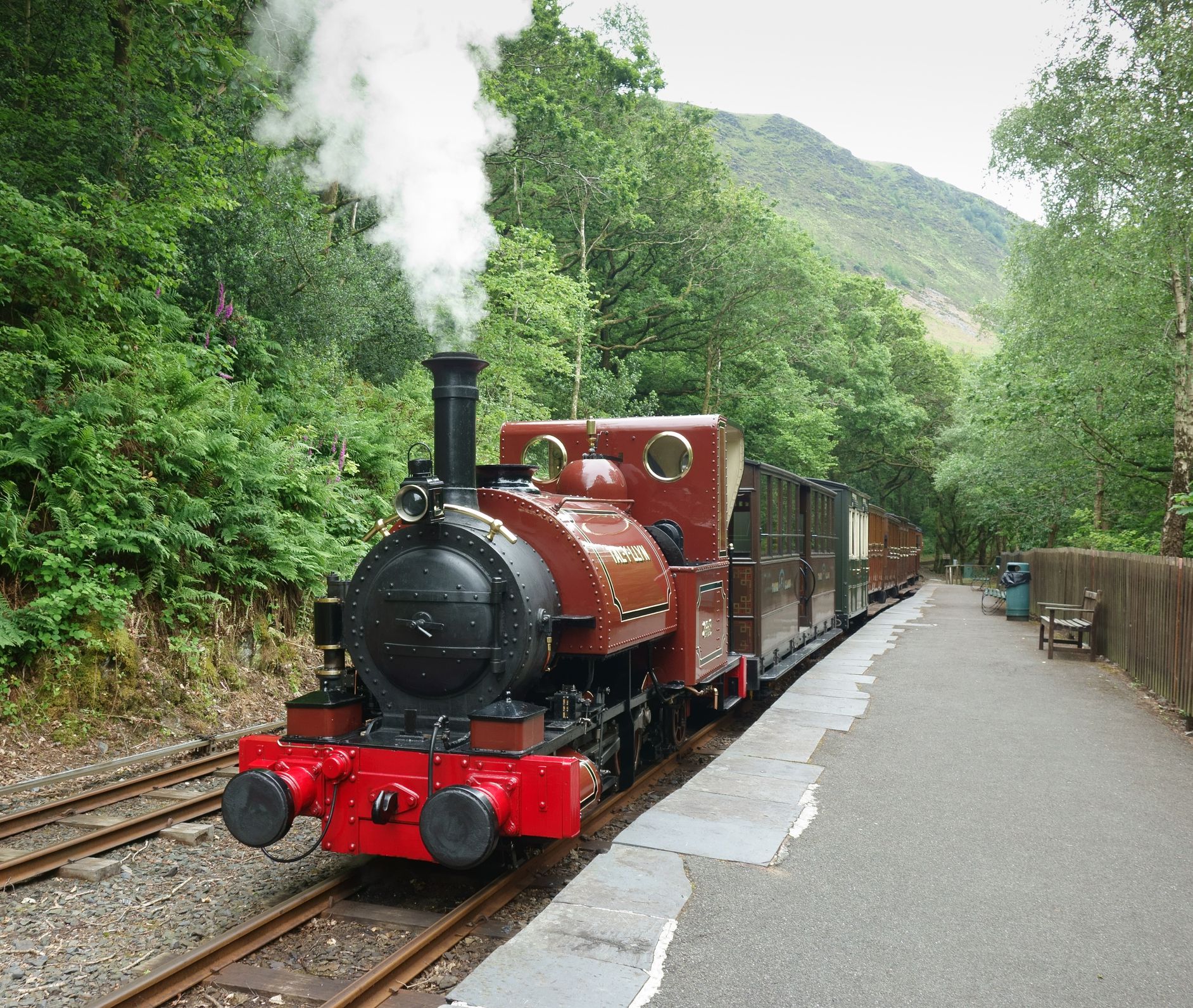 Nant Gwernol, Wales, UK - June 25th, 2015: Steam train at platform on the The Talyllyn Railway, a narrow-gauge preserved railway in Wales running from Tywyn on the Mid-Wales coast to Nant Gwernol near the village of Abergynolwyn.