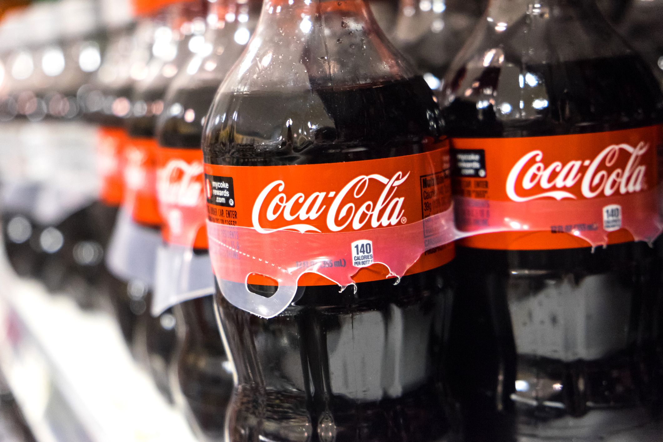 Miami, Florida, USA- March 27, 2014: 12 Fl ozs Plastic Bottles of Coca Cola in a warehouse Rack. The soft drink called also Coke is sold in over 200 countries worldwide.