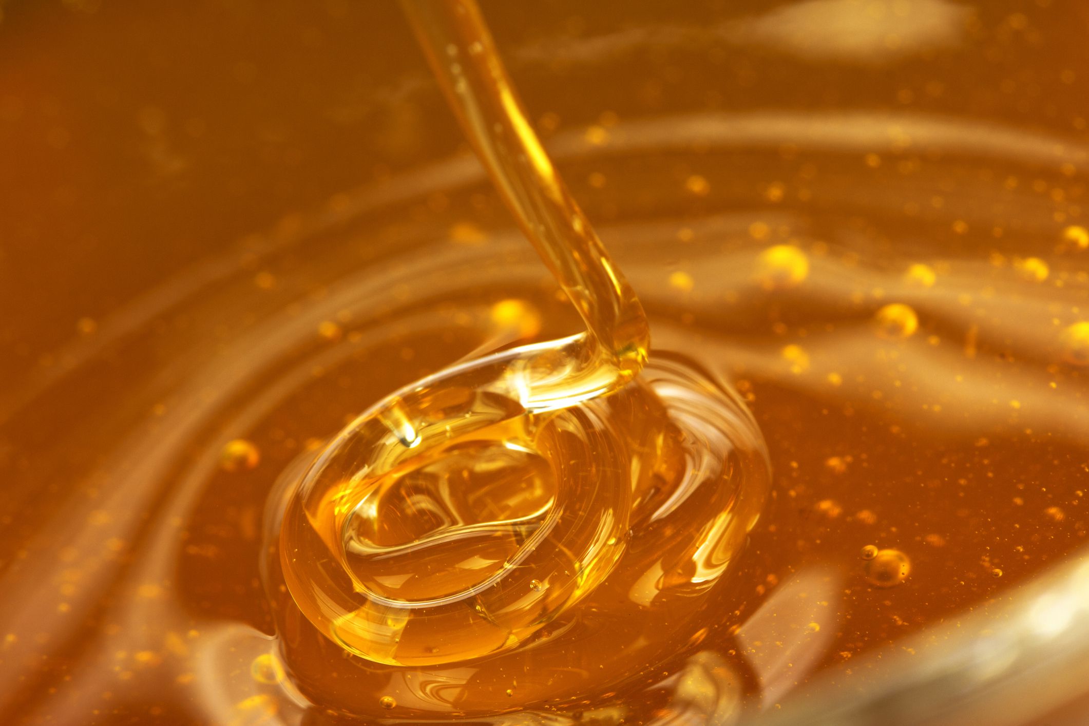 Honey pouring into dish