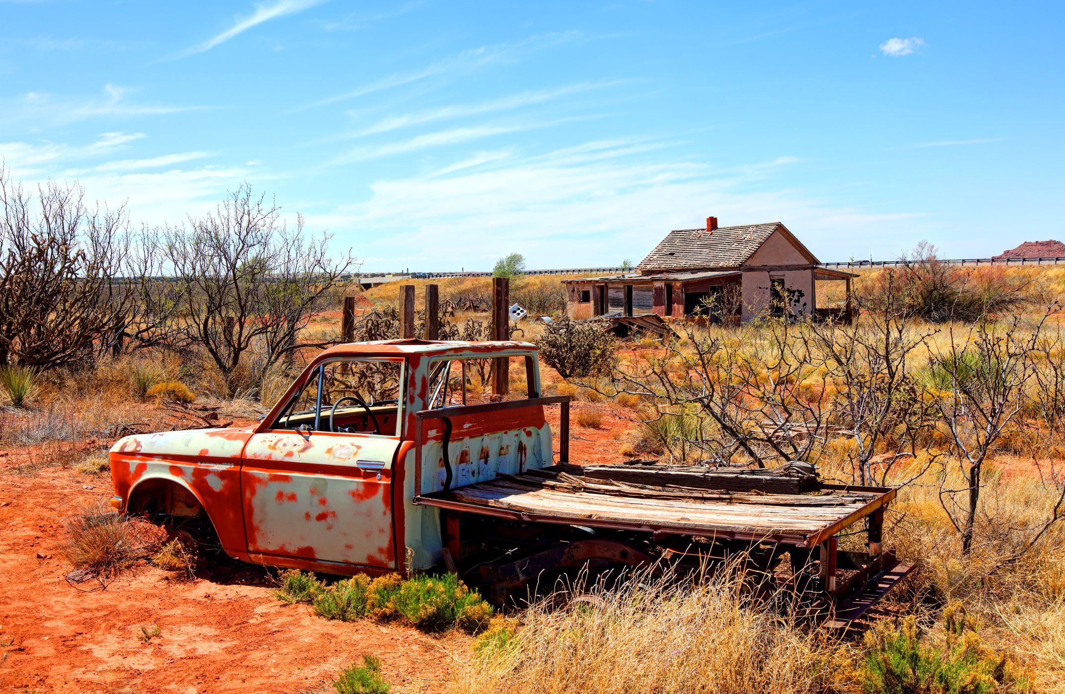 Cuervo, New Mexico, USA - April 22, 2018: Daytime view of the desolate ghost town of Cuervo littered with abandoned cars and buildings