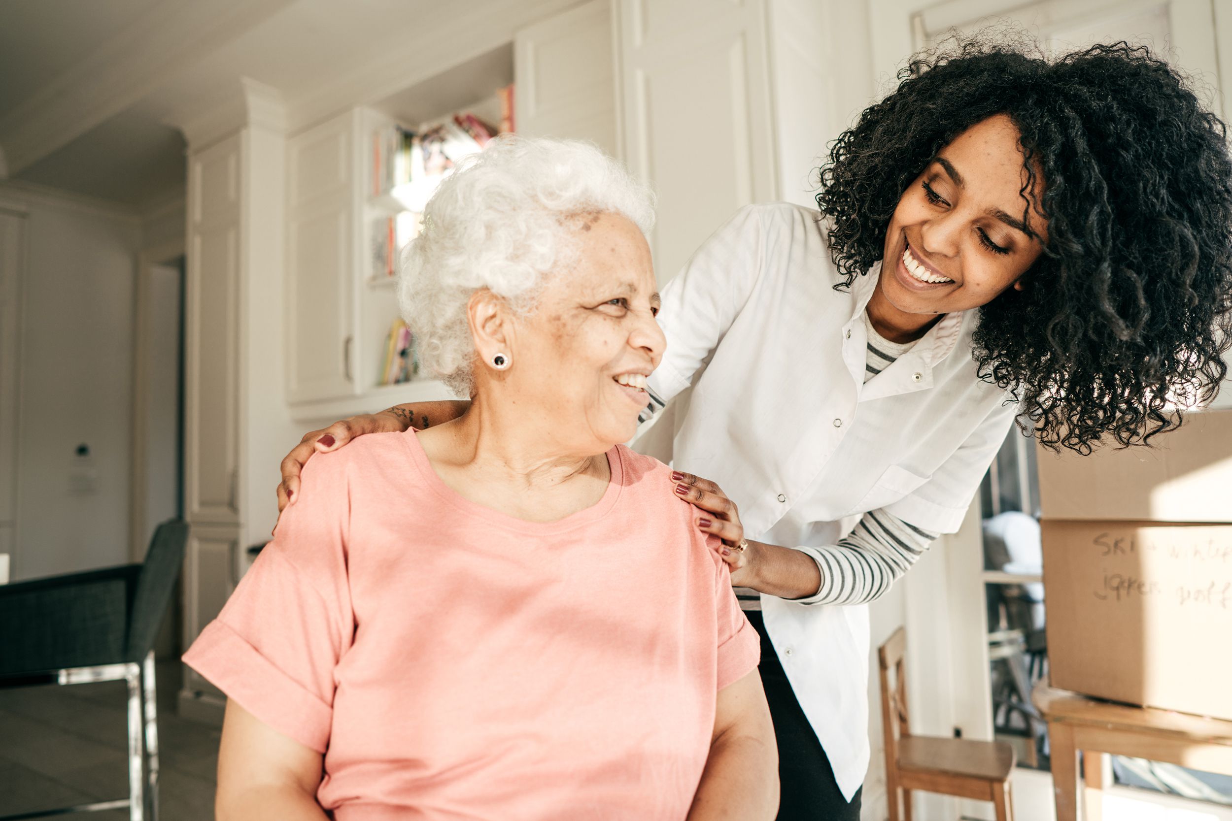 nurse visiting senior lady at home