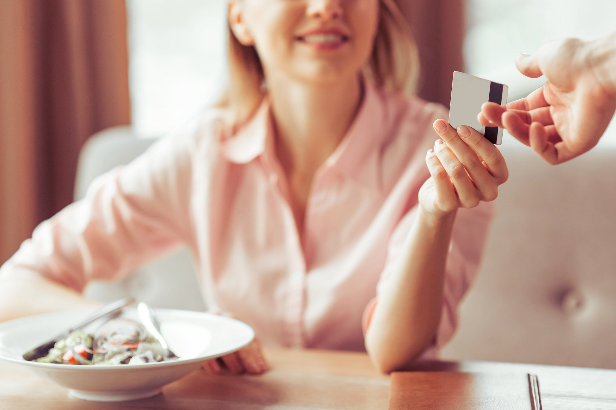 business woman is paying with a credit card