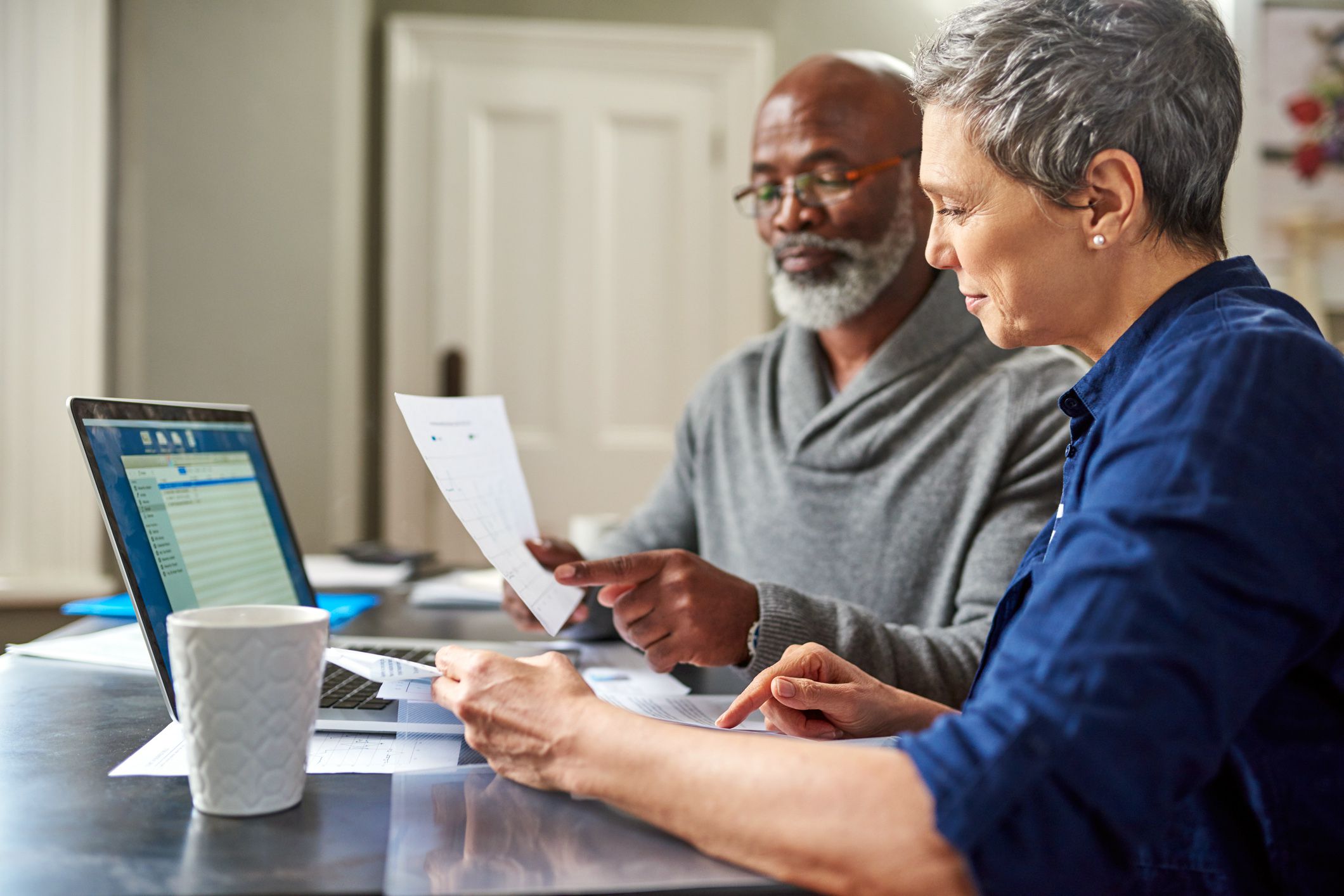 senior couple smiling at finances