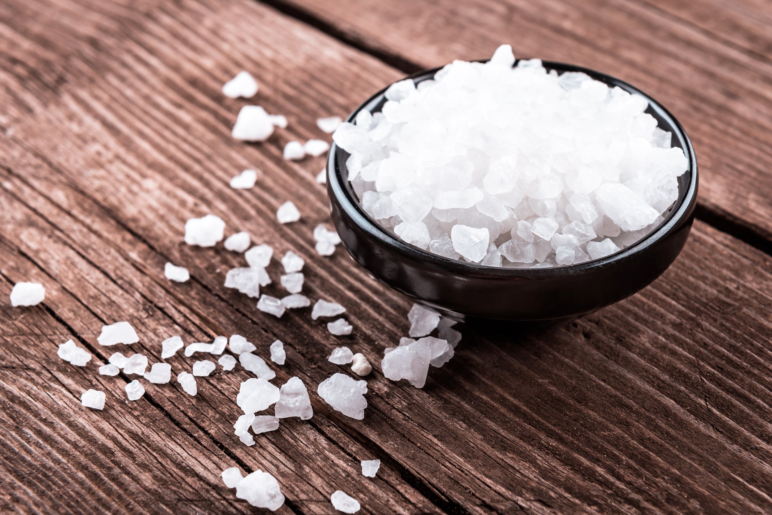 sea salt in bowl on wooden background