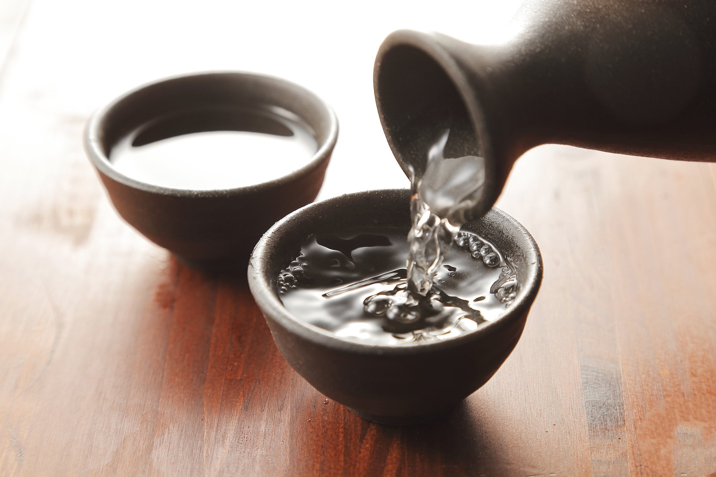 hot sake being poured into cup