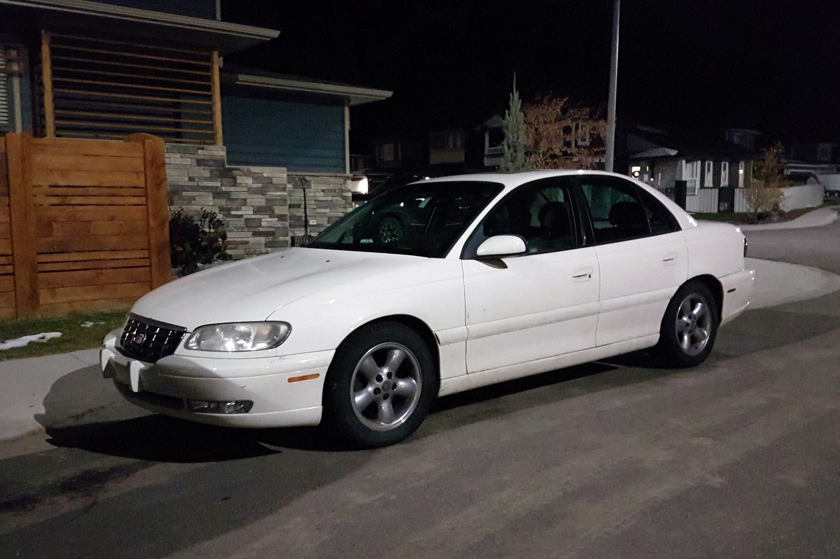 white cadillac casera at night