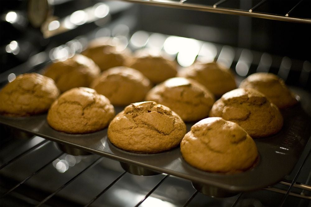 Buckwheat Gingerbread Muffins in a Muffin Tin on a Rack in the Oven