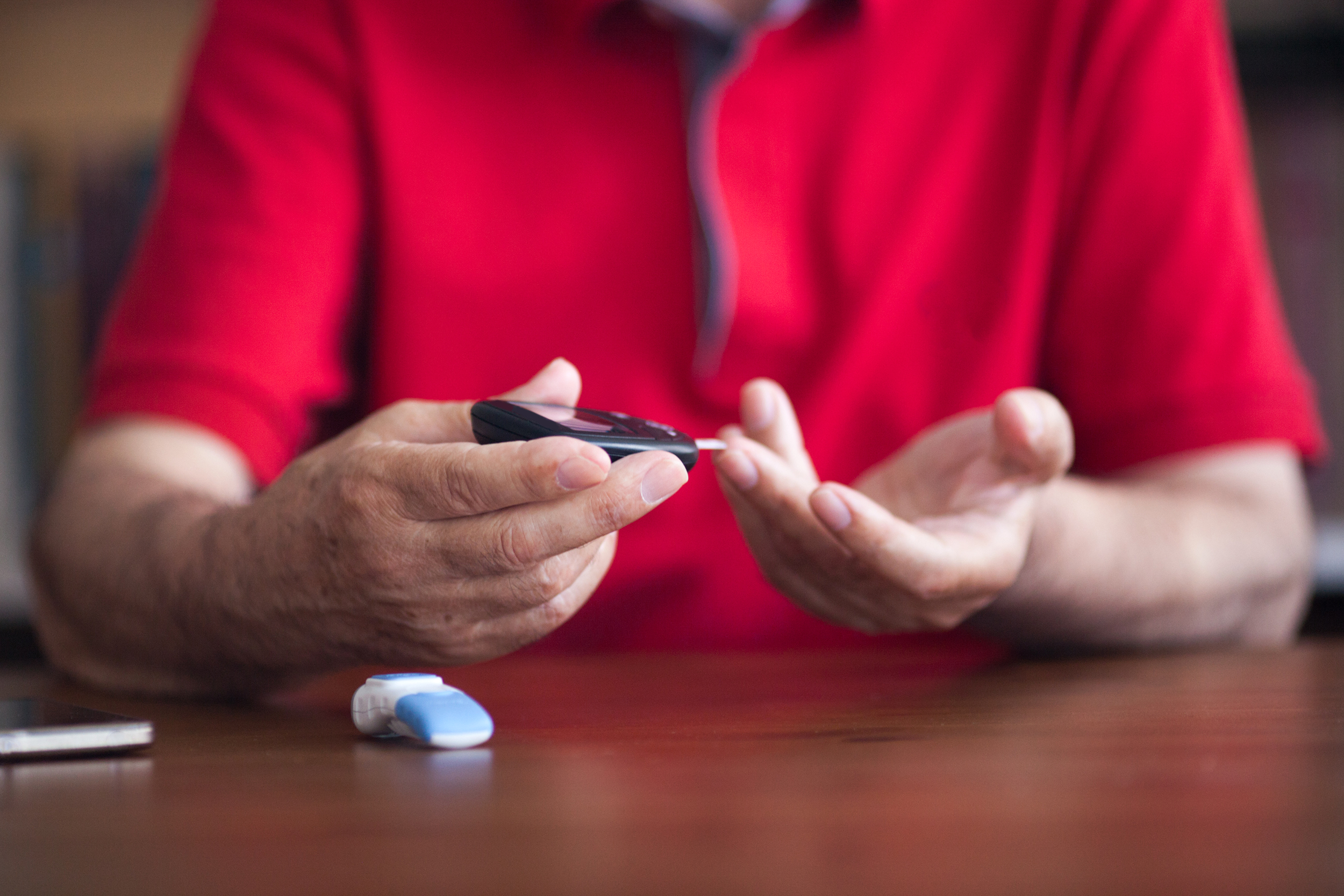 Man pricking his finger for a blood sugar test