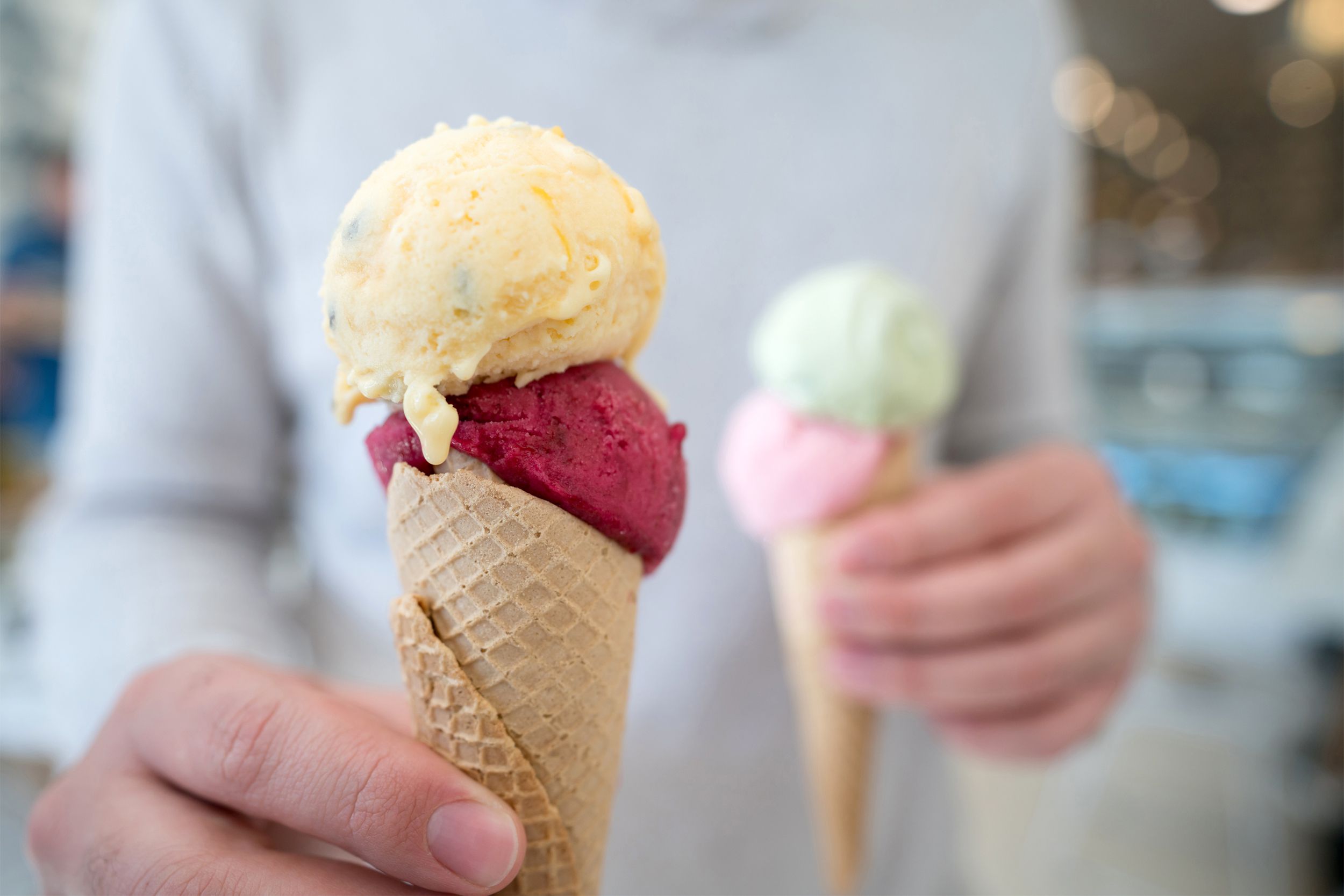 Closeup of man holding ice cream cones