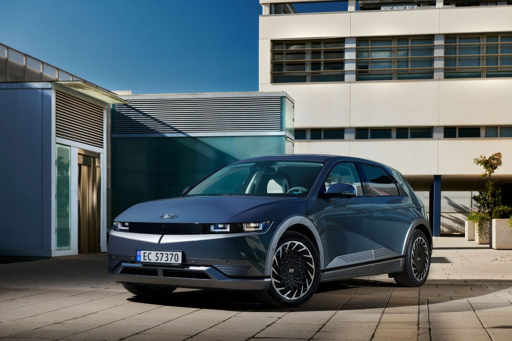 Blue Hyundai Ioniq 5 parked in front of building