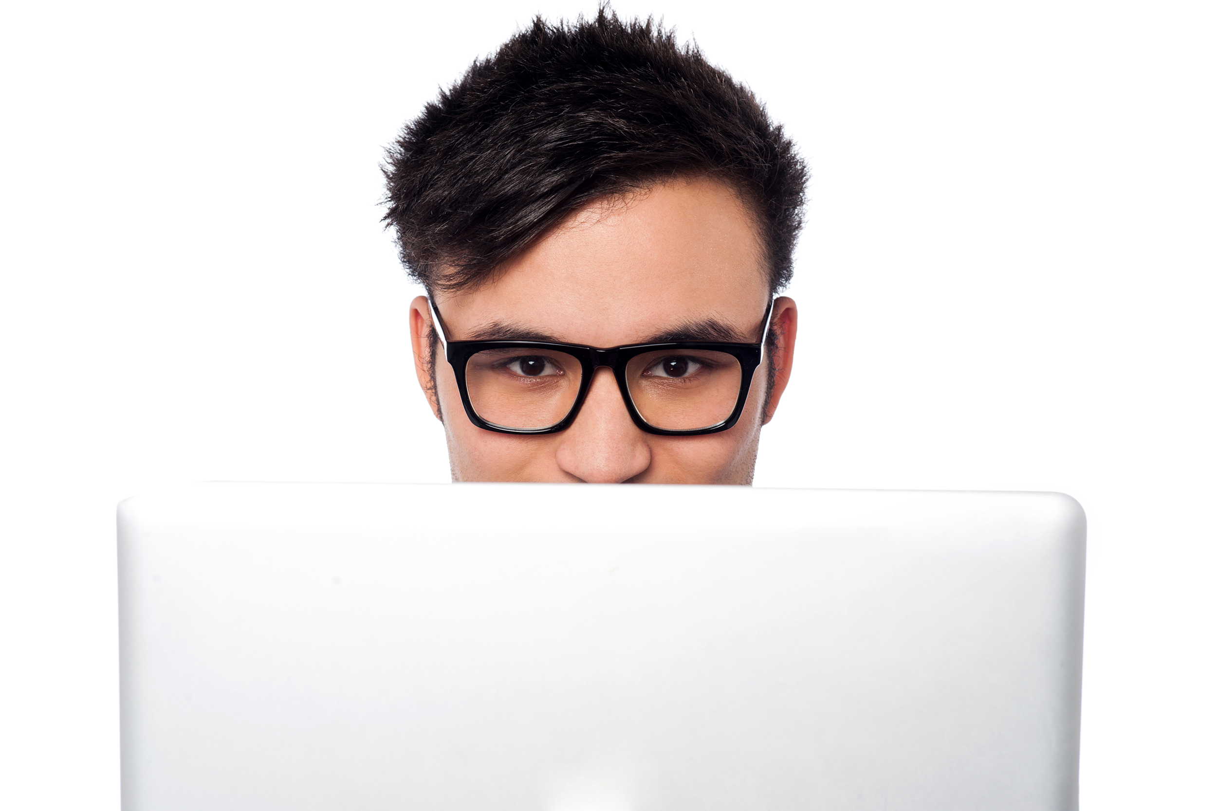 Man peering over his laptop suspiciously