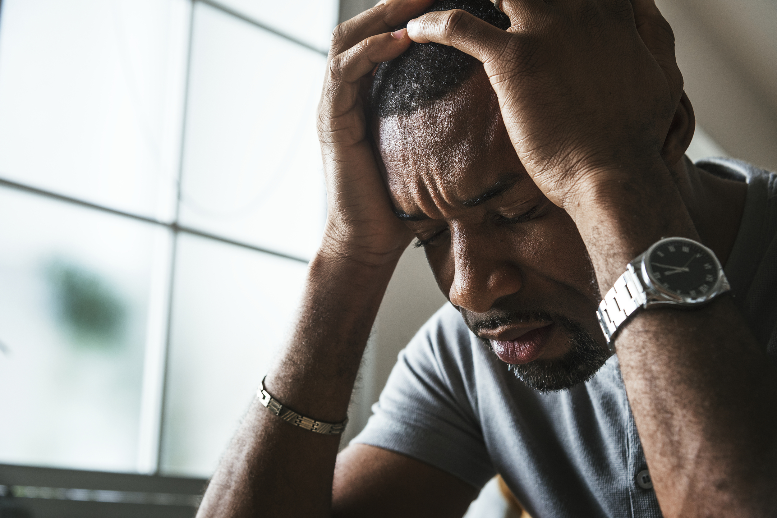 Man holding his head down depressed