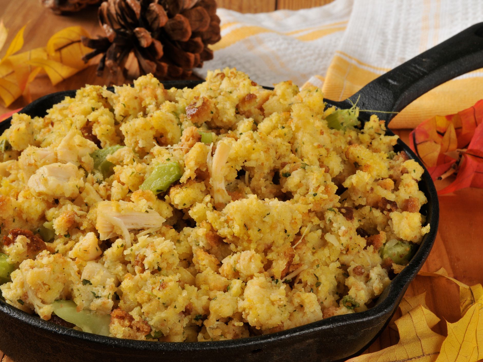 Cornbread stuffing with turkey and celery in a cast iron skillet