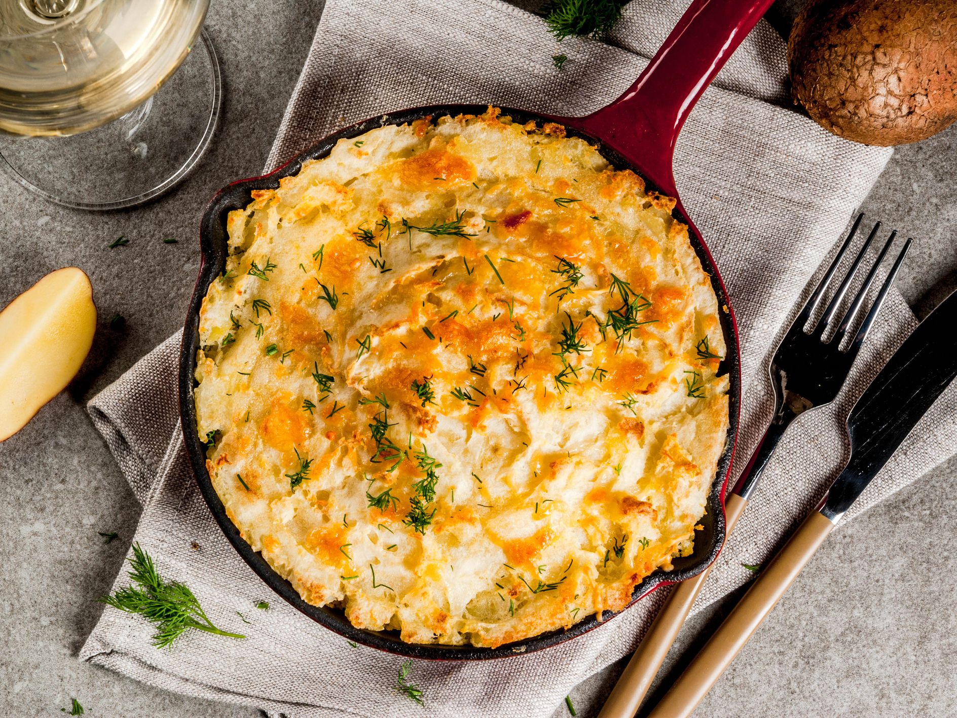 Skillet Shepherd's Pie, british casserole in cast iron pan, with minced meat, mashed potatoes and vegetables, on dark rusty background, copy space top view