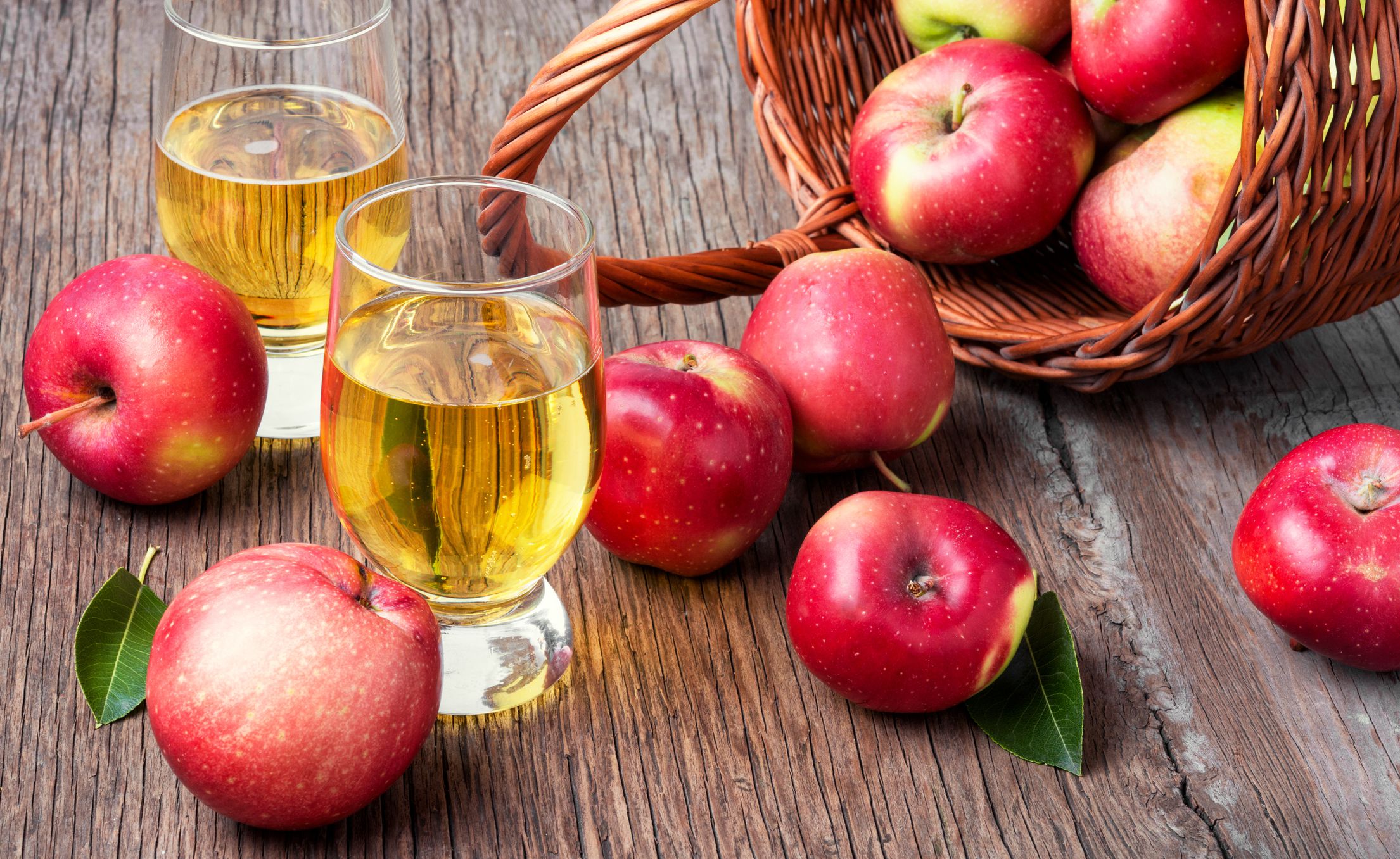Apple cider with fresh apples on rustic background.Apple cider cocktail