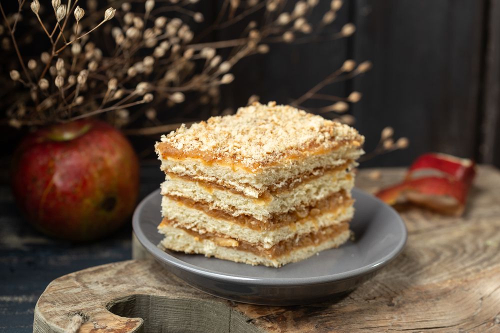 a piece of apple cake on wooden board