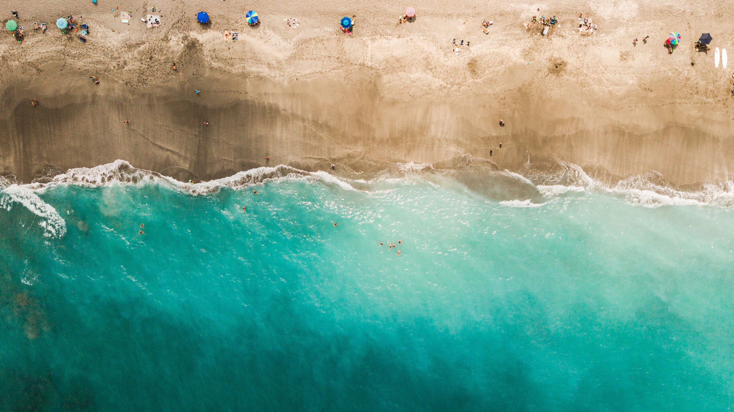 Aerial Views of Colorful Beach Umbrellas on Jupiter Beach, Florida at Mid-Day During COVID-19 in April of 2021