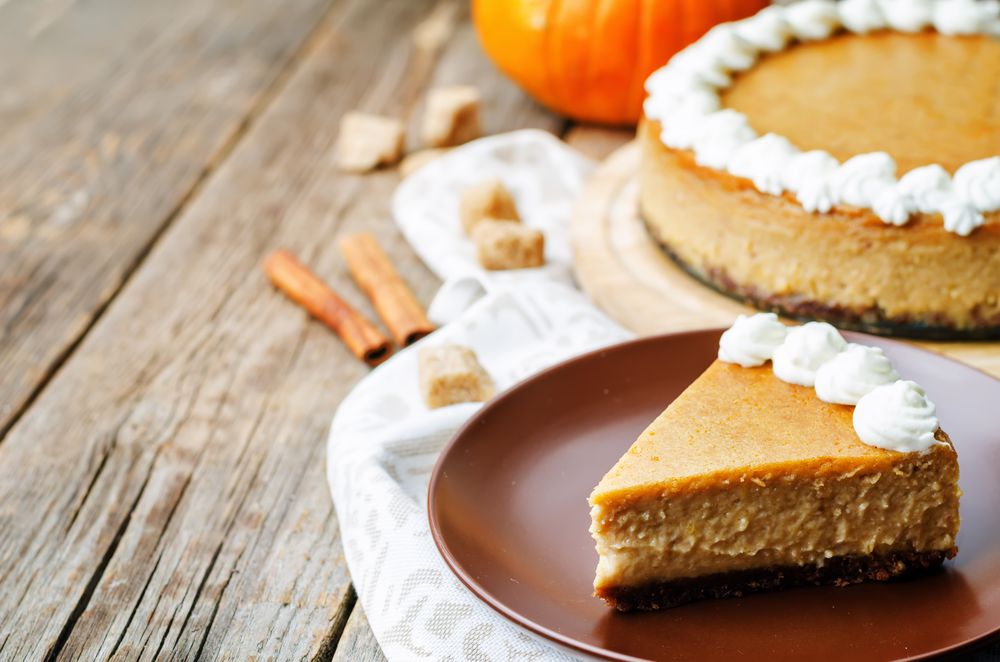 pumpkin cheesecake decorated with whipped cream