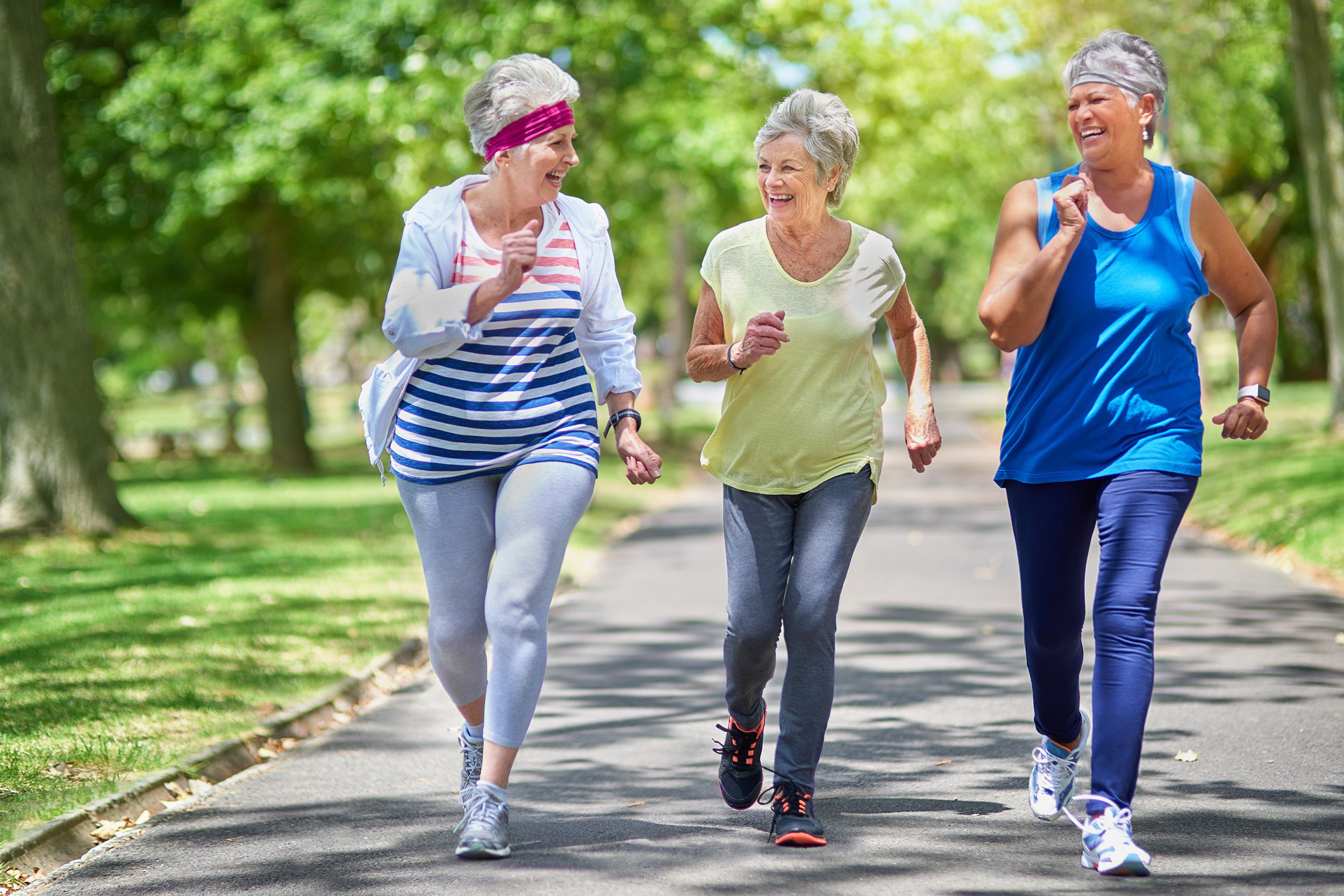 group of senior women fast-walking in park