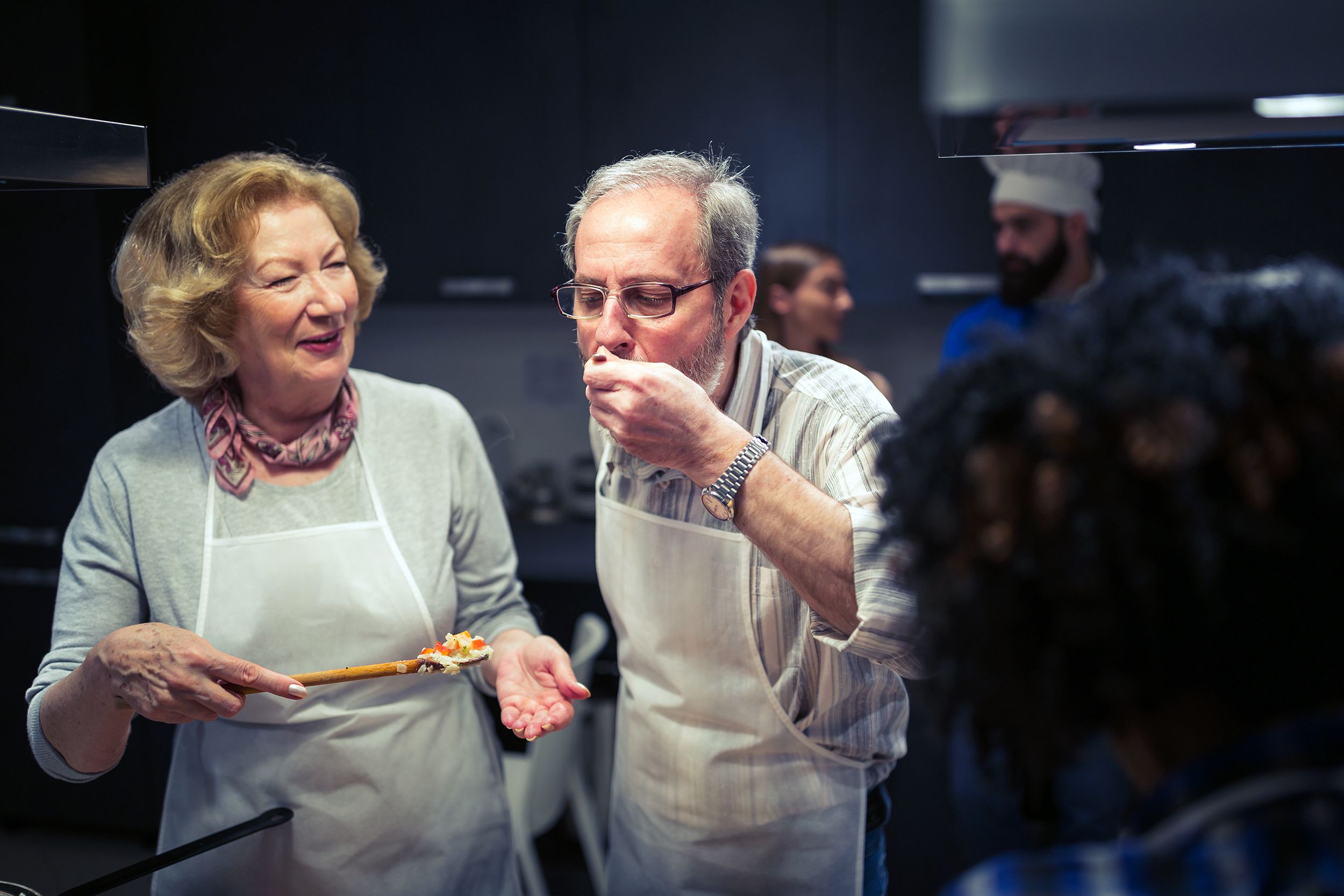 senior couple enjoying cooking class