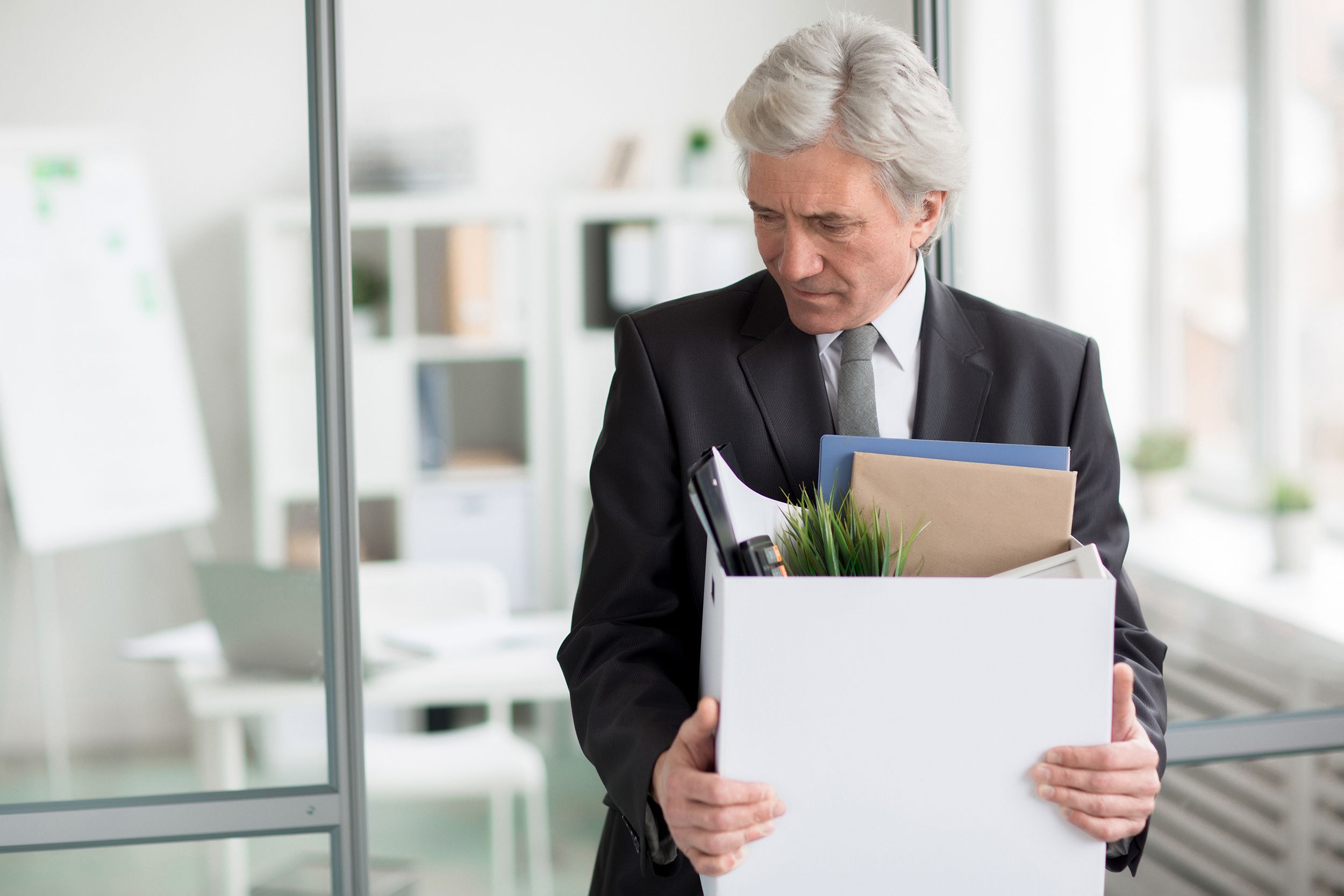 thoughtful but sad senior man leaving work for retirement
