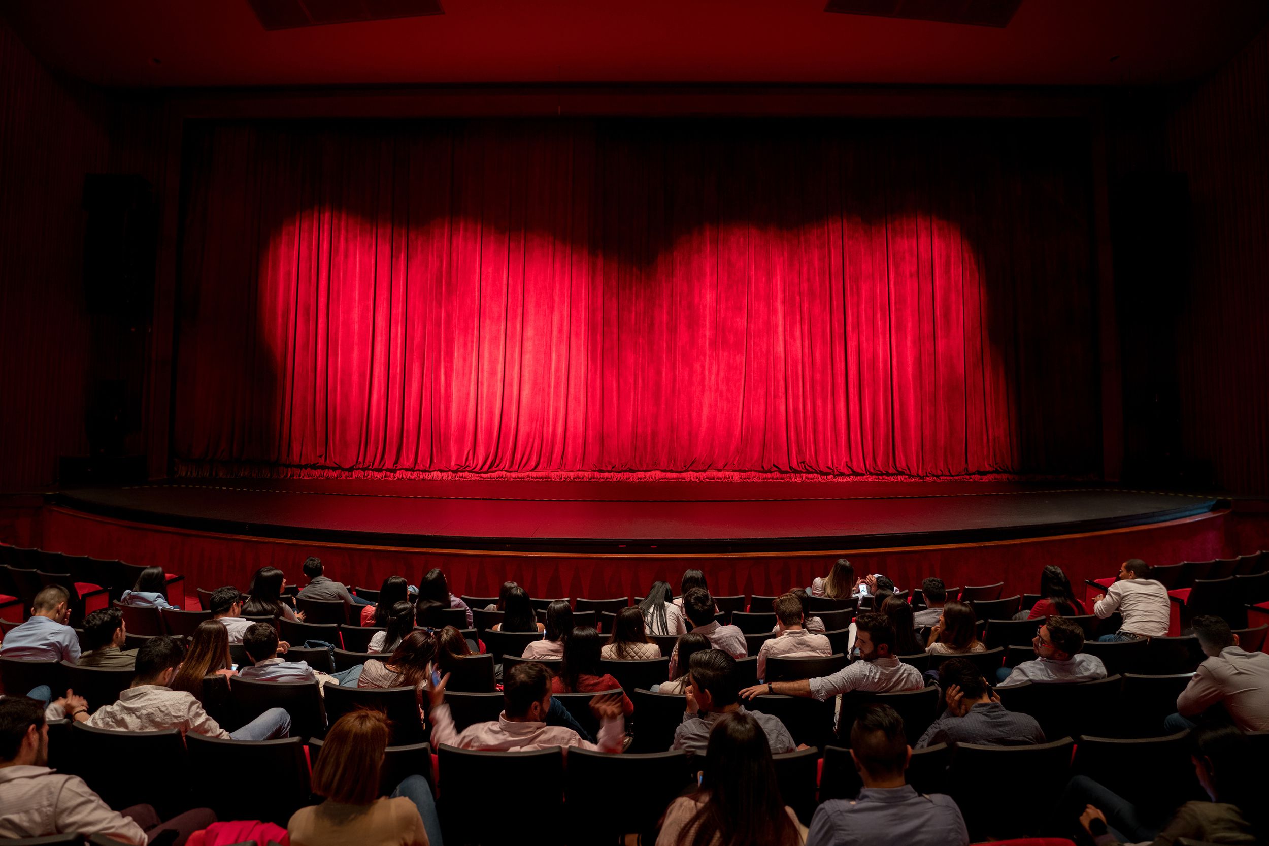 anxious audience waiting for the curtains to open to see the performance