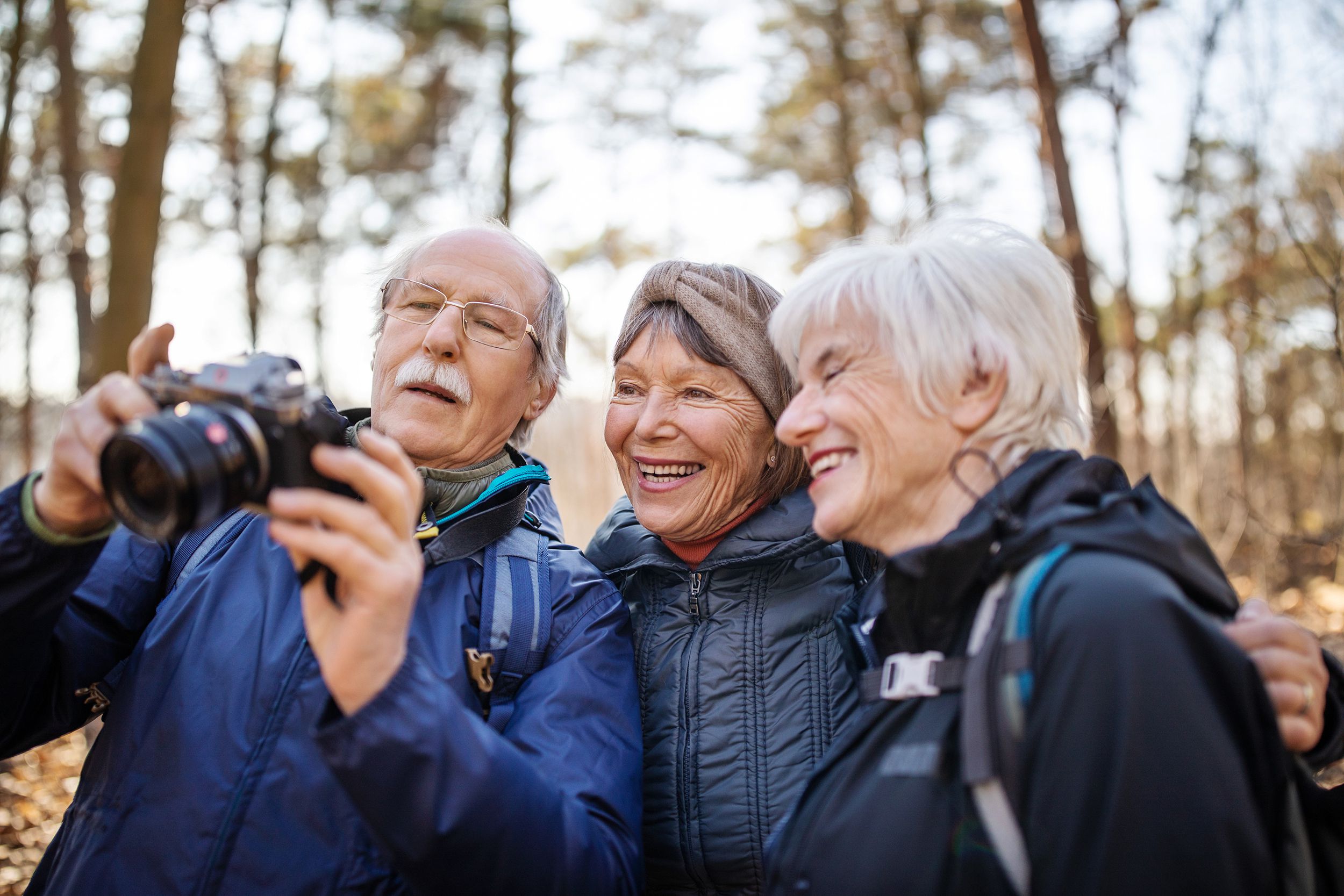 senior hikers looking at their pictures on camera