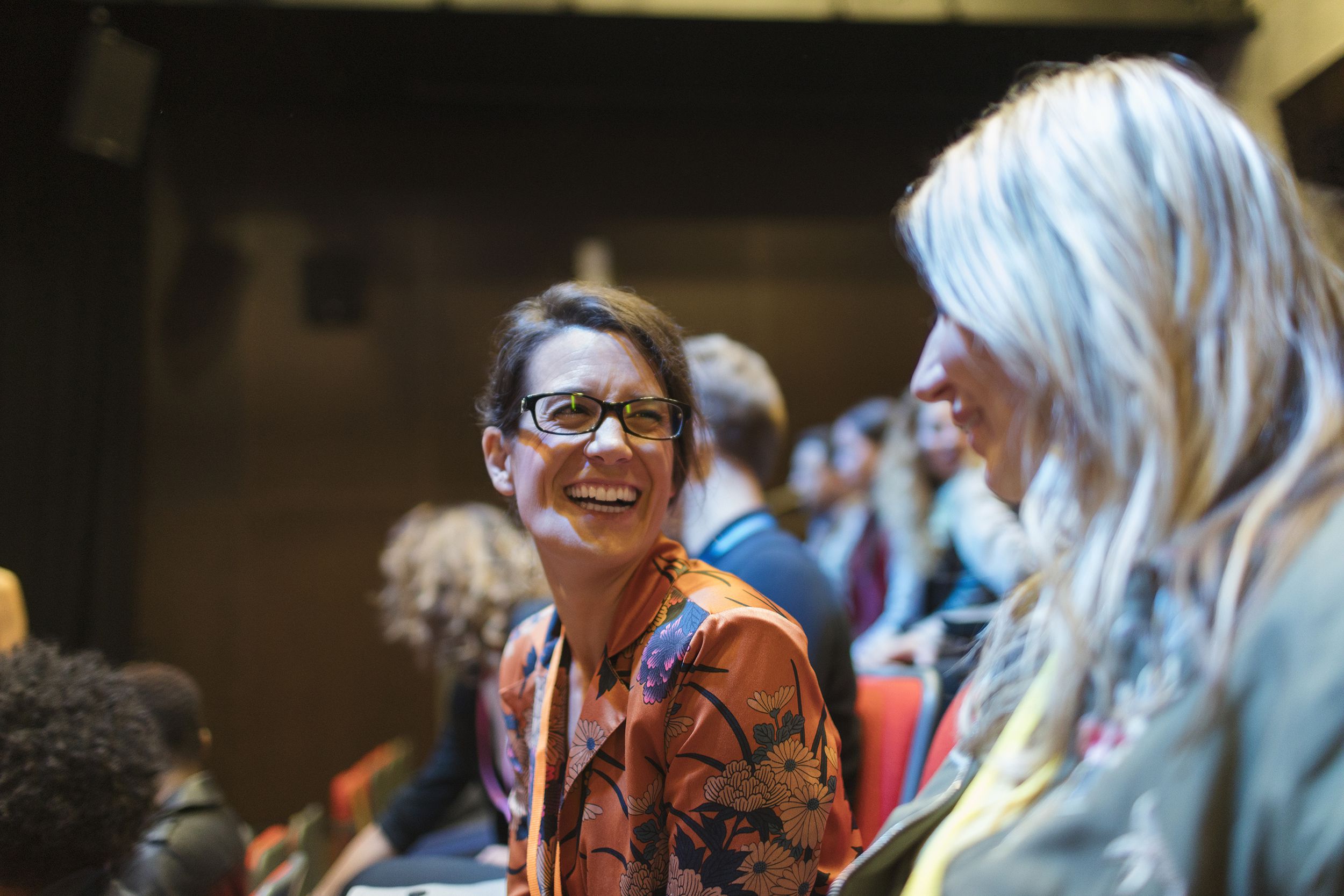 laughing middle-aged women in conference audience