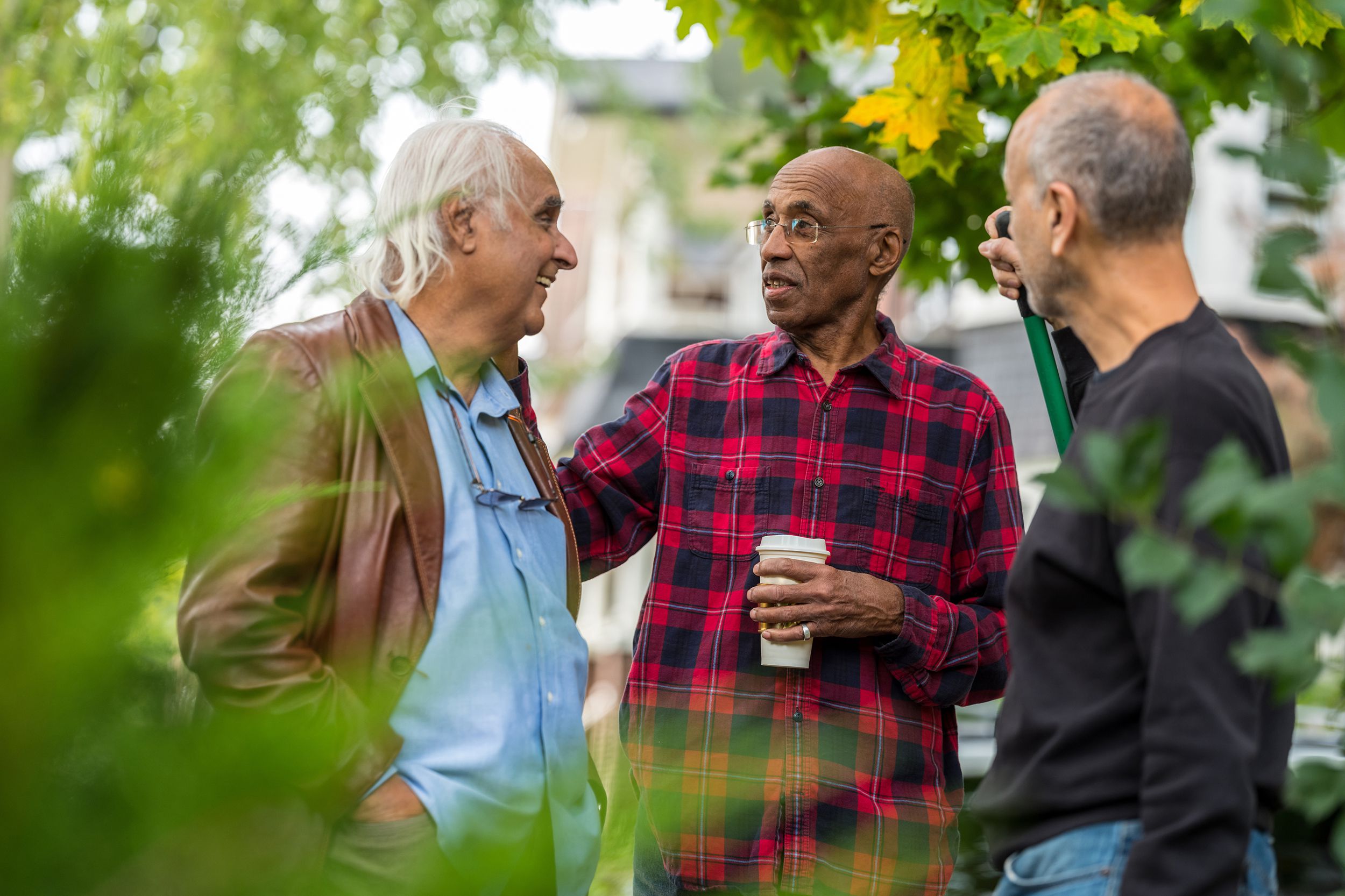 senior neighbors having a friendly chat outside