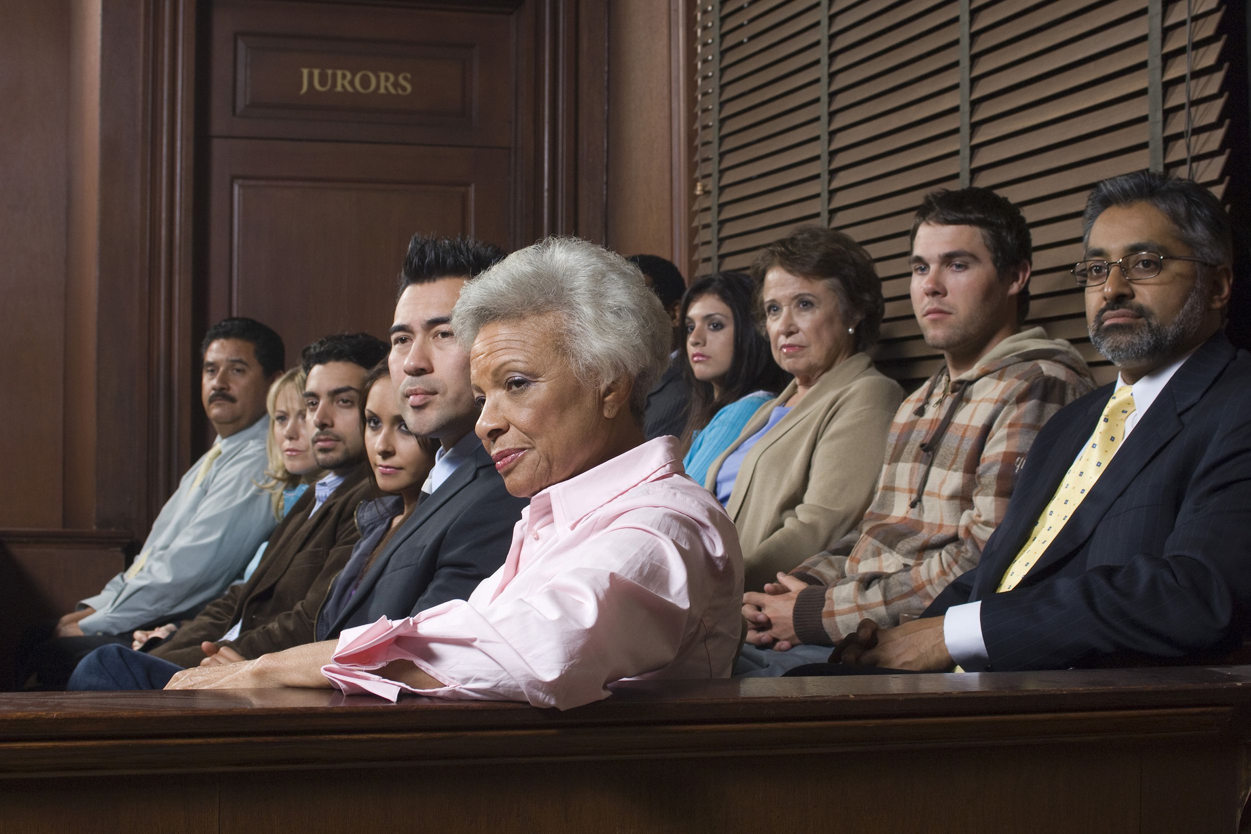 diverse group of people sitting in a courtroom