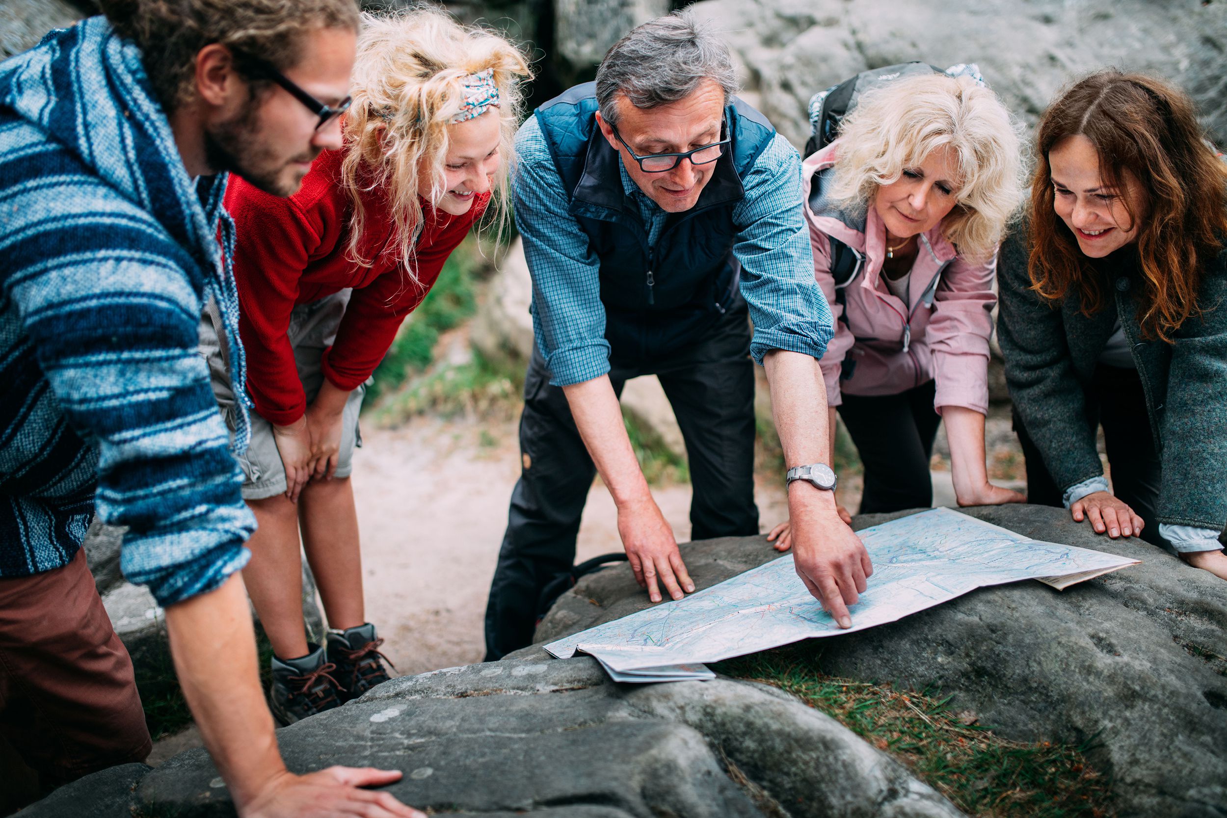 group of hikers checking route on map