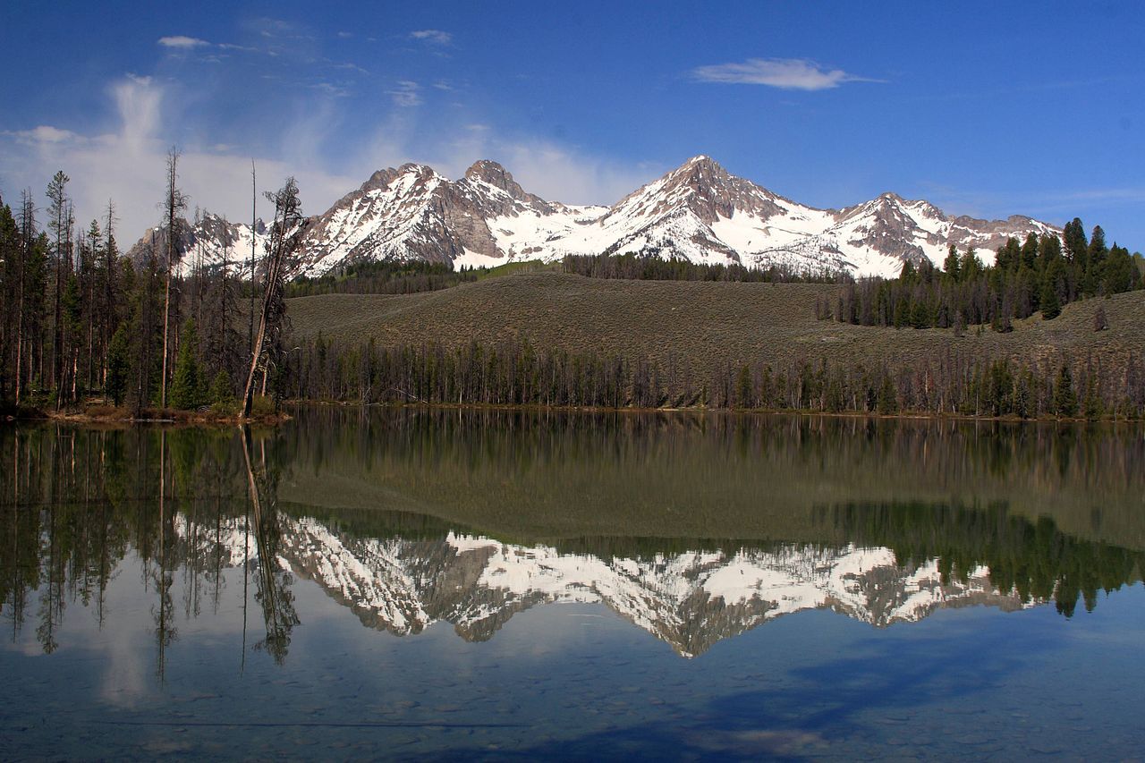 Mountains in the Sawtooth Range (Thompson and Williams peaks) reflected on Little Redfish Lake near Stanley, Idaho