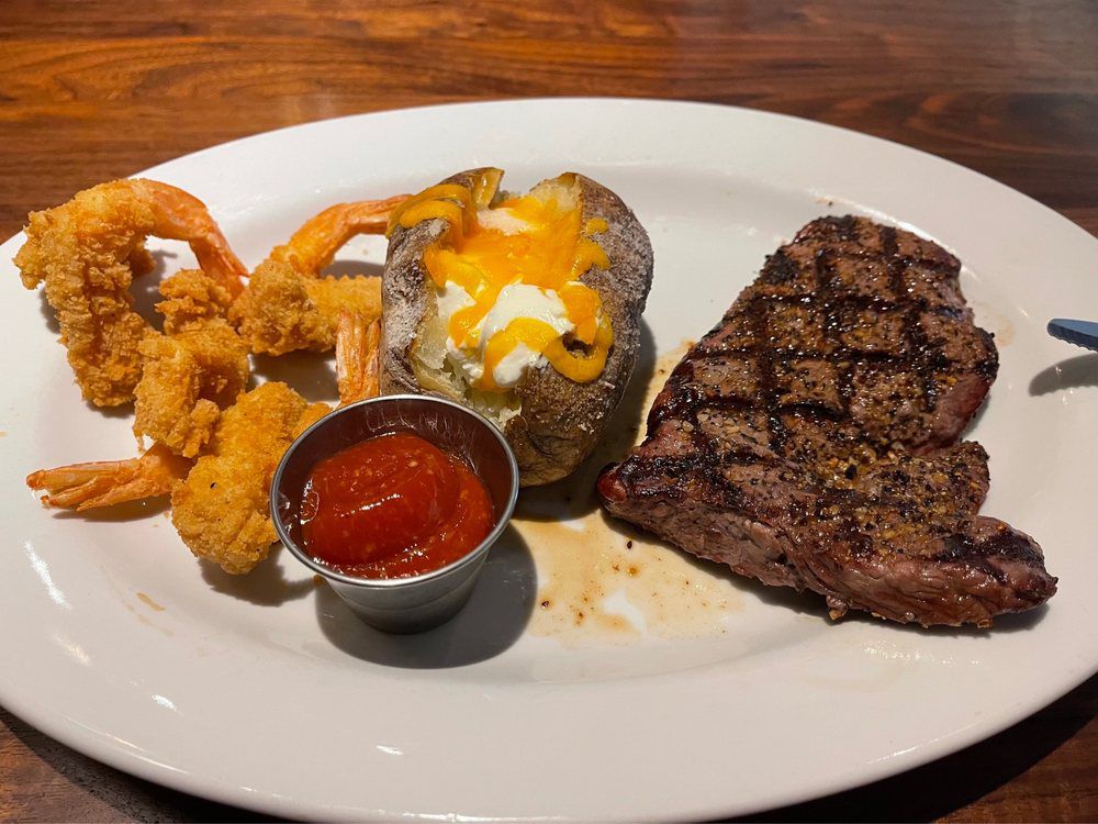 Fried shrimp, baked potato, and steak from Gibbons Shreveport