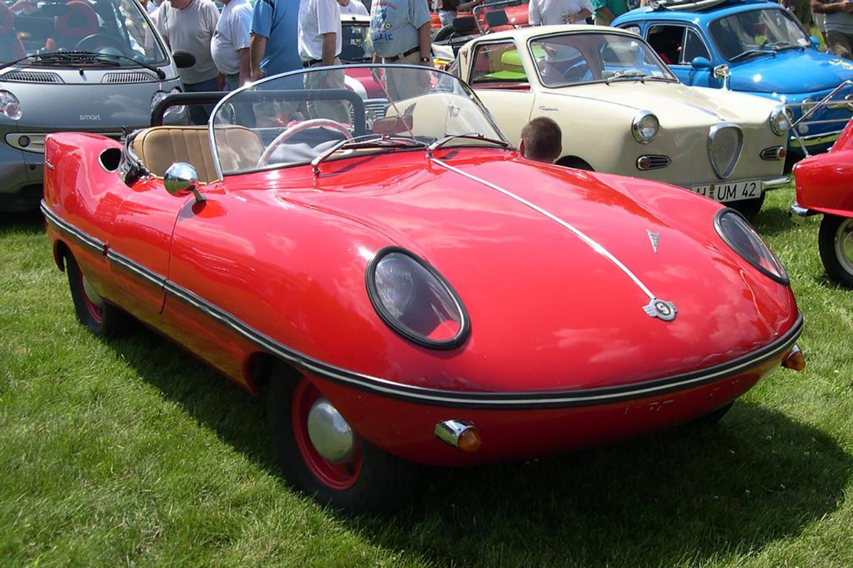 Red Goggomobil Dart parked on grass