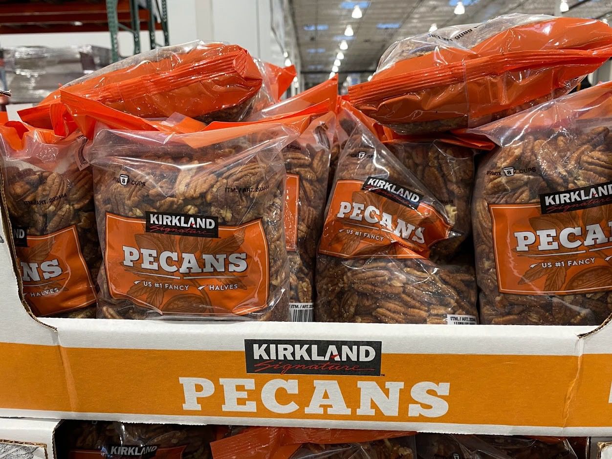 Kirkland Signature Pecans in plastic bags on shelf in Costco.