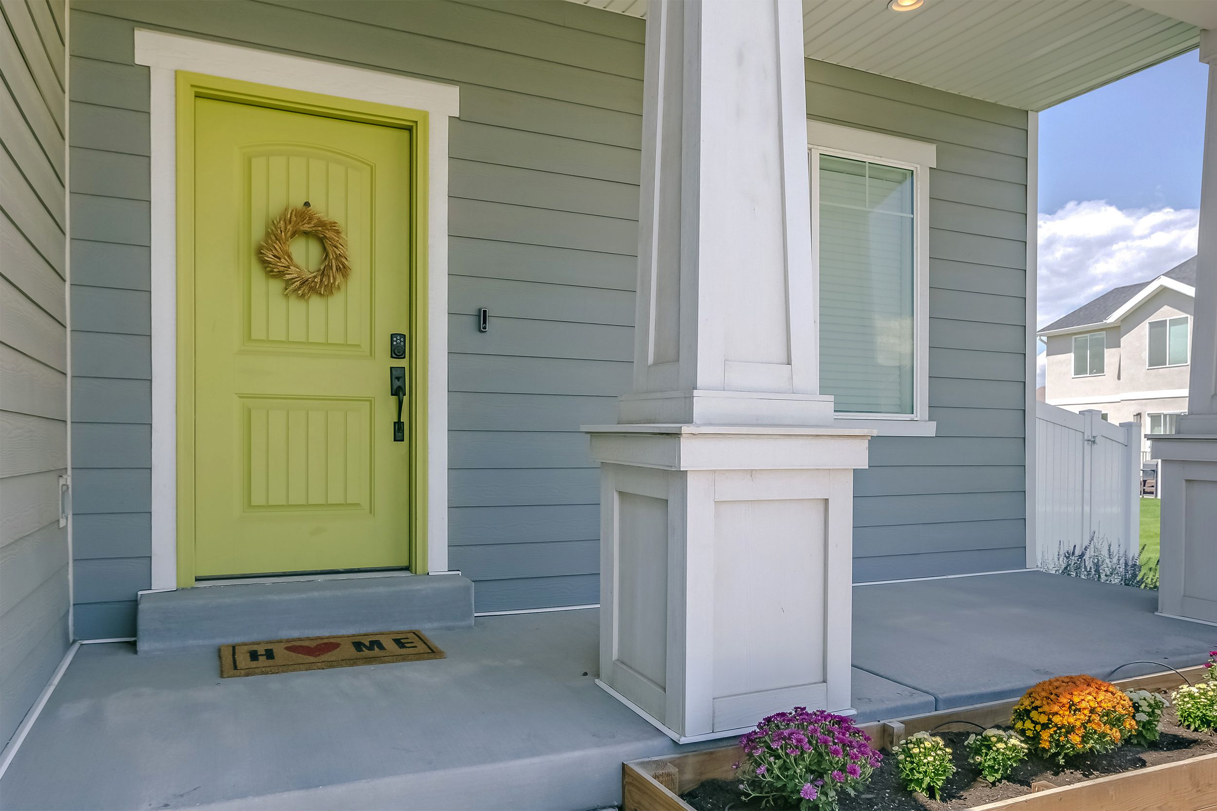Home with porch and flowers in the garden