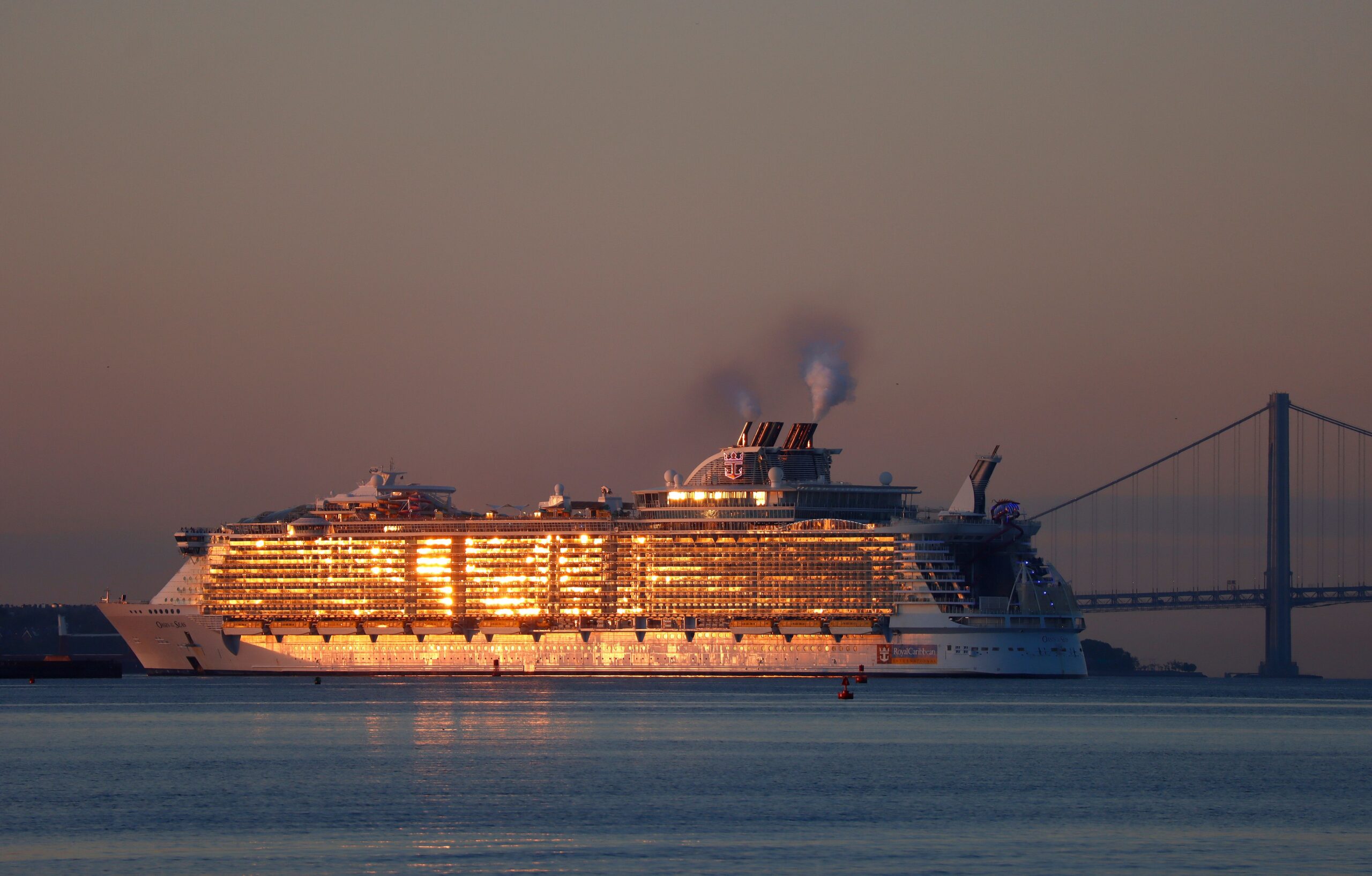 The Royal Caribbean Oasis of the Seas cruise ship returns to its port in Bayonne, New Jersey as the sun rises on May 29, 2022, as seen from Jersey City, New Jersey.