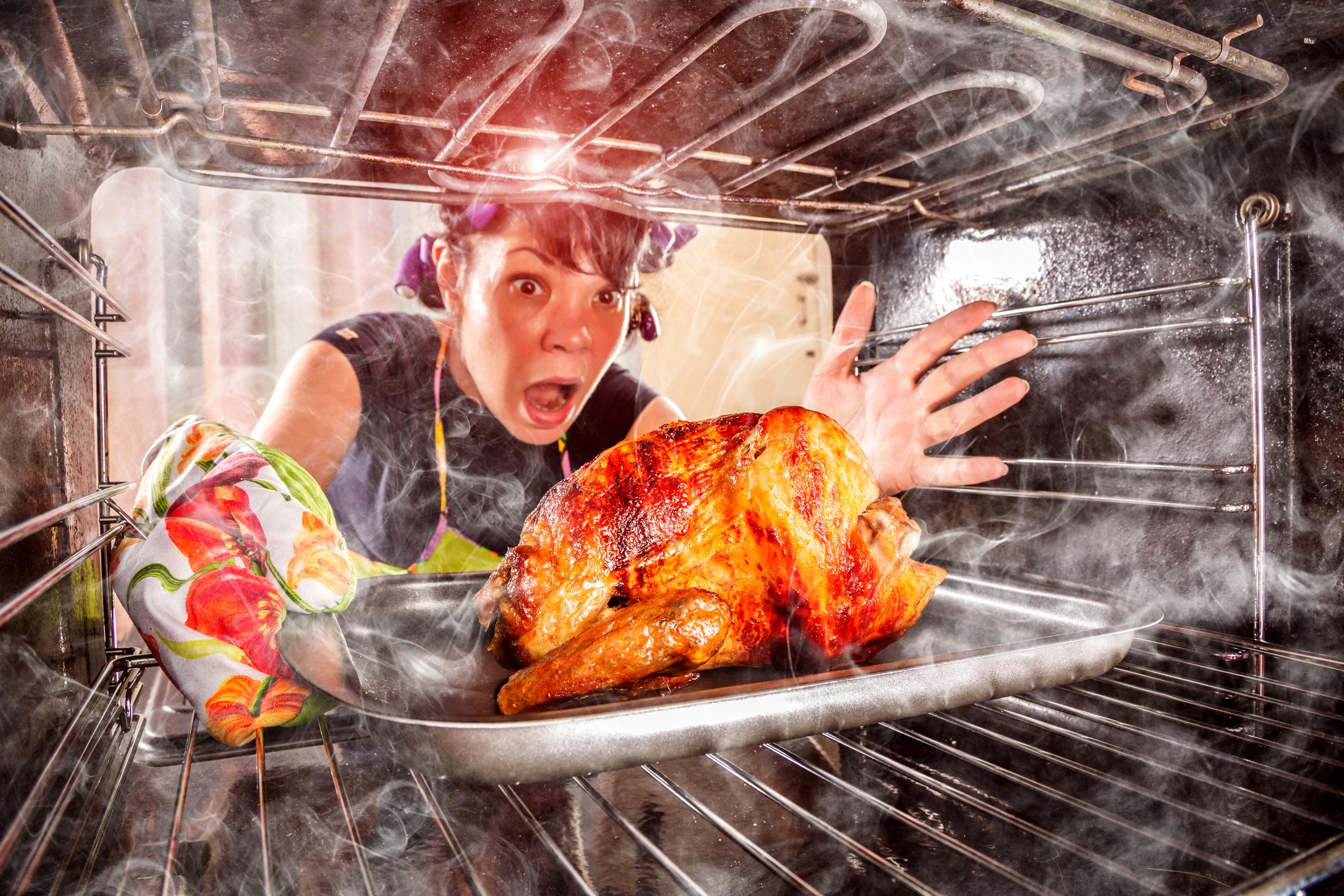 Funny Housewife overlooked roast chicken in the oven, so she had scorched (focus on chicken), view from the inside of the oven. Housewife perplexed and angry. Loser is destiny! Thanksgiving Day.