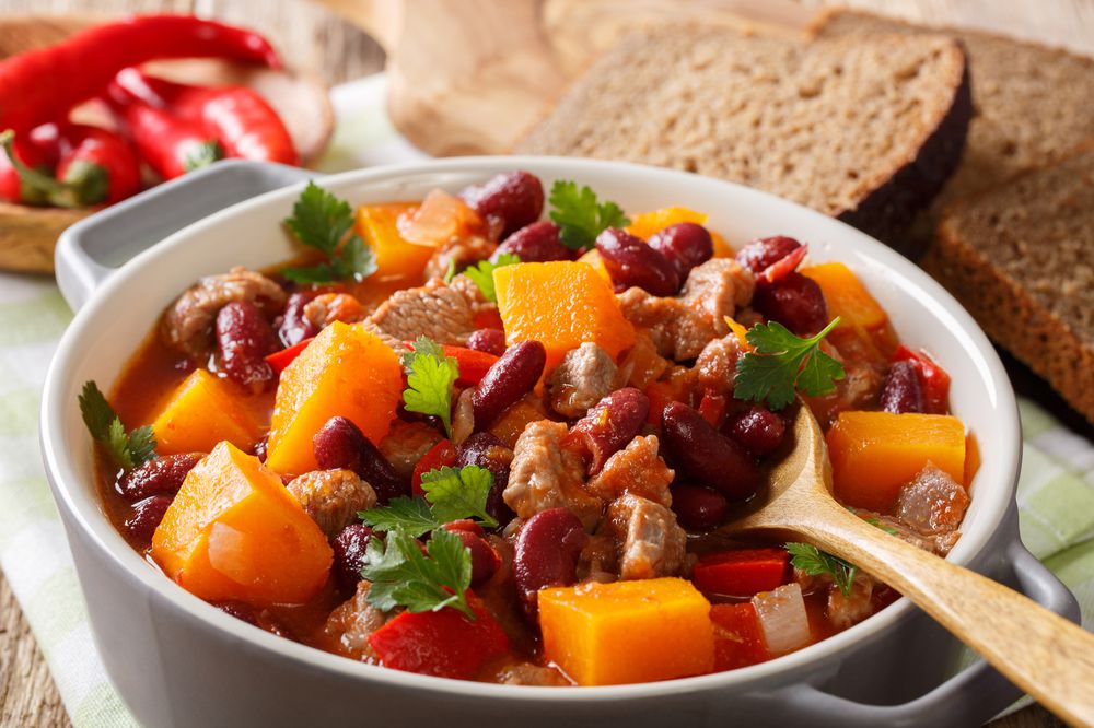 delicious pumpkin stewed with meat and vegetables close-up in a saucepan. horizontal