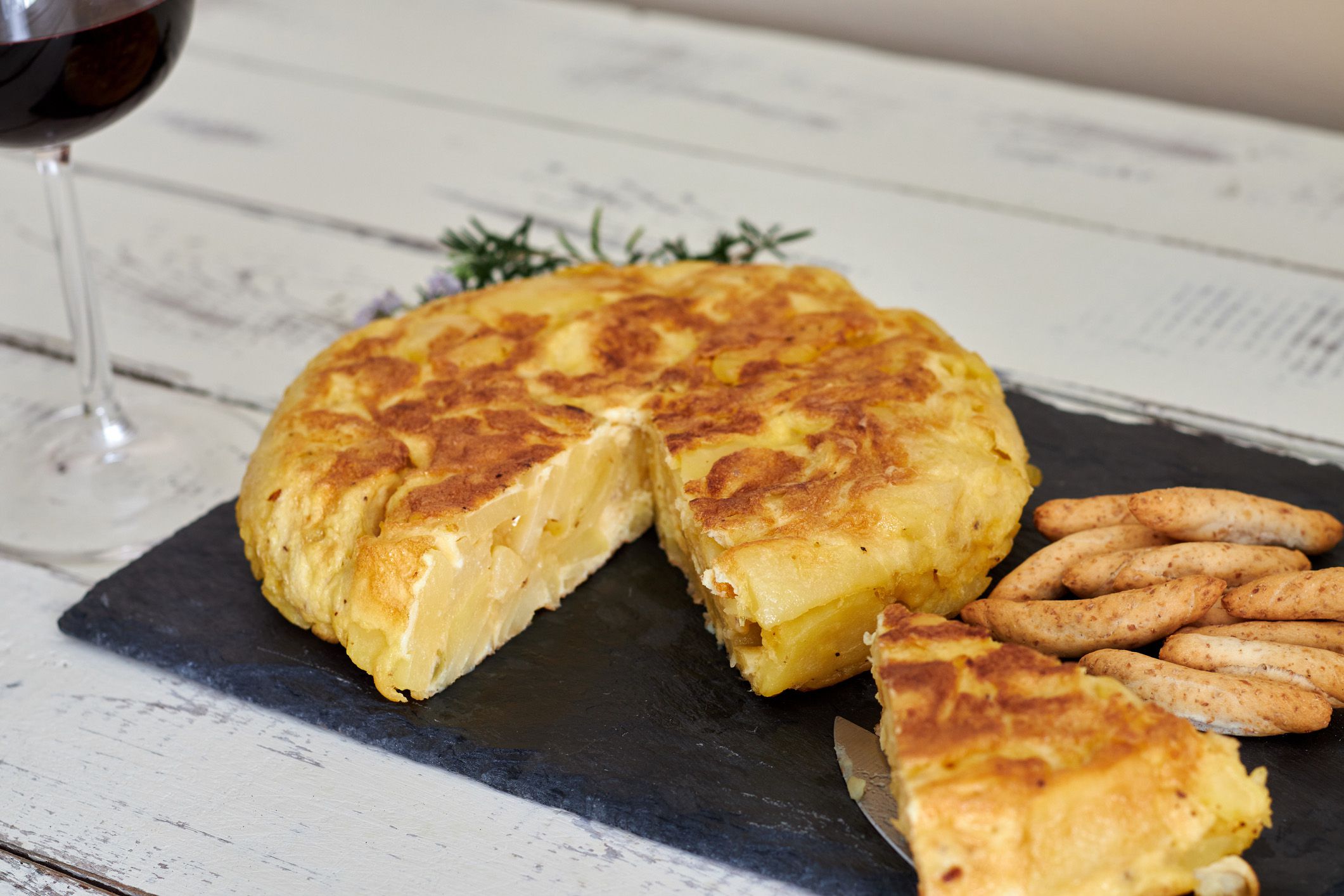 tortilla de patata with breadsticks and wine
