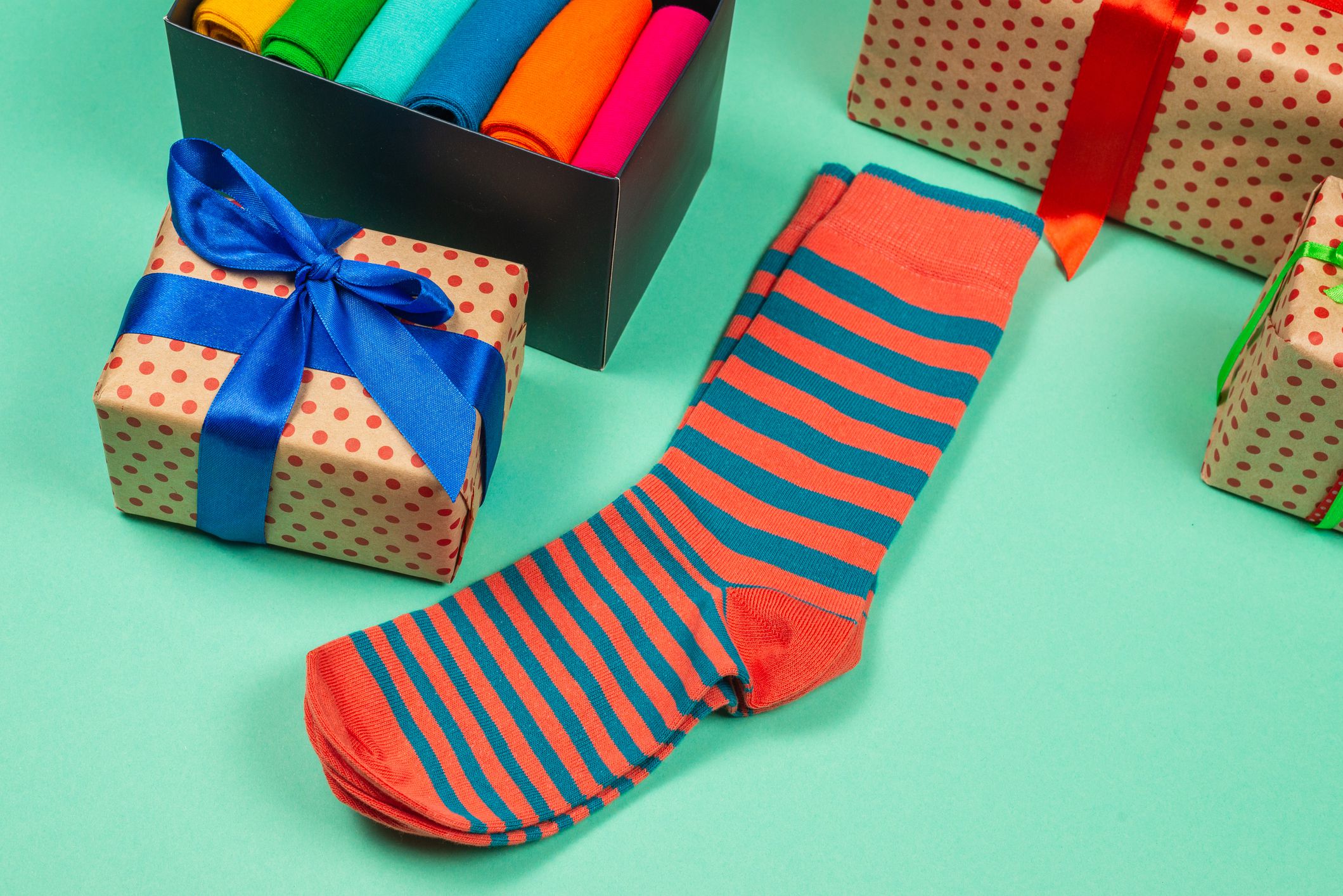 Colorful collection of cotton socks as a gift in woman hands. Gift.