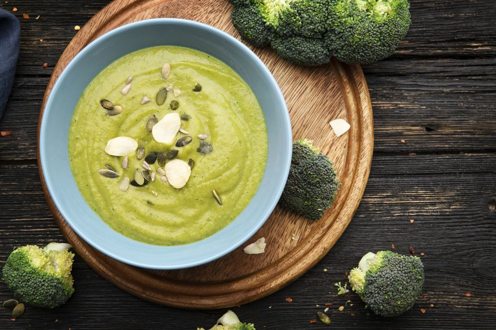 Broccoli cream soup on wooden background