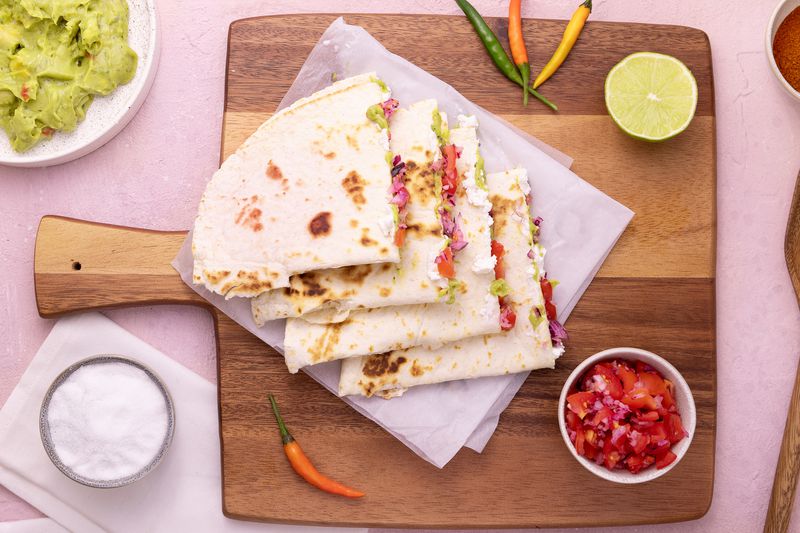 Quesadilla with cheese, tomato, lime and guacamole