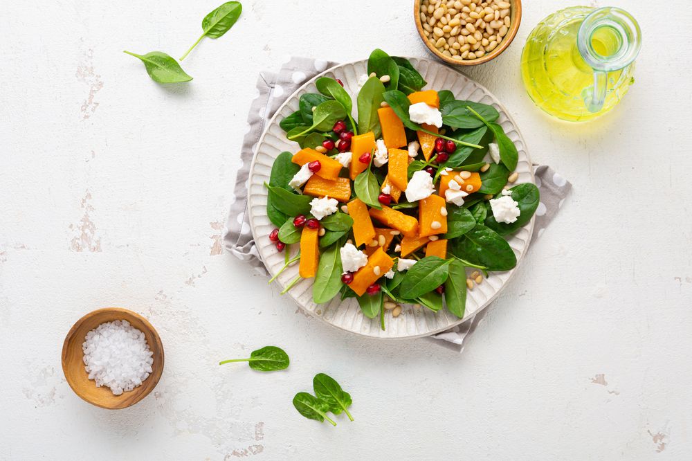 Overhead view of roasted butternut pumpkin salad on white plate