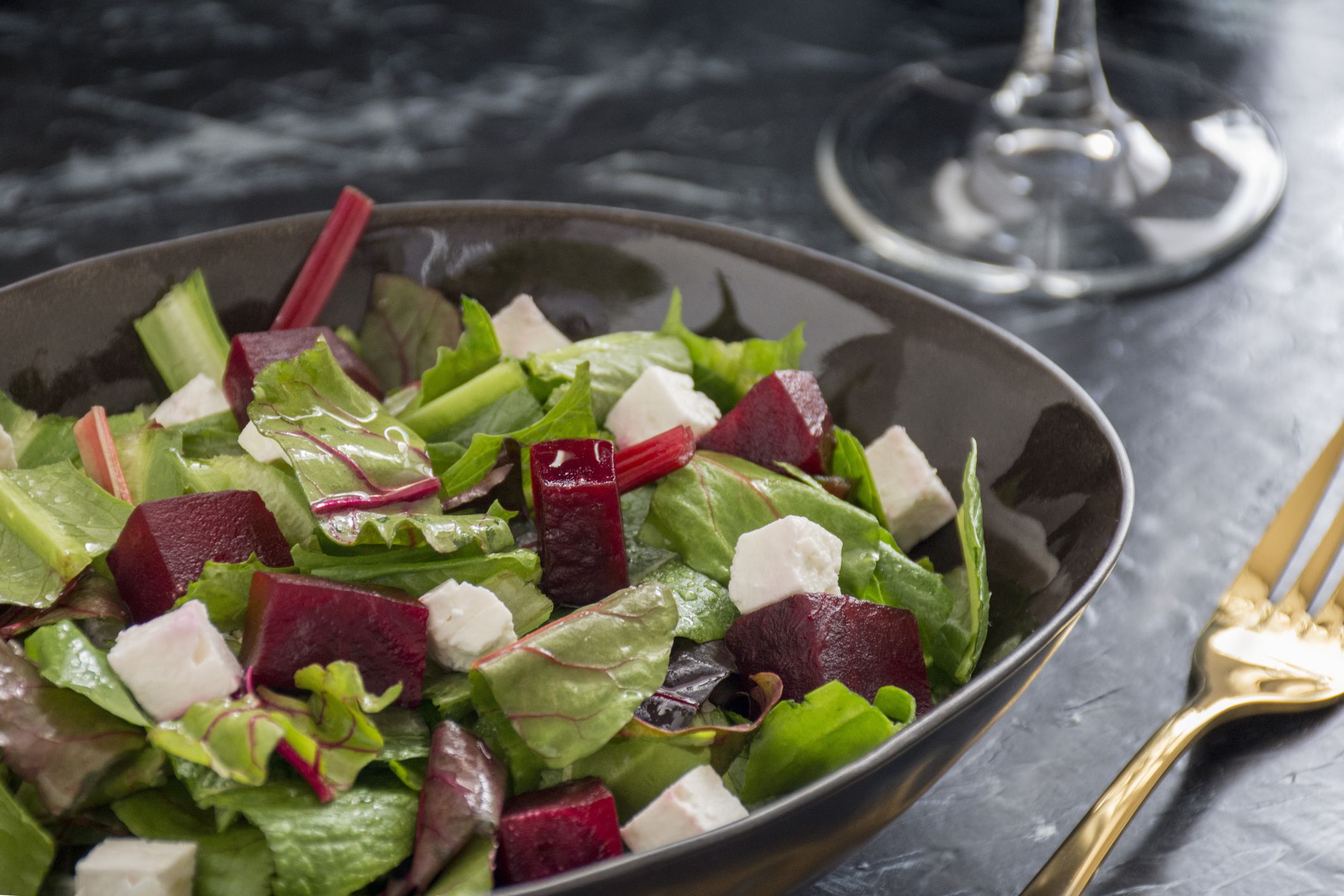 Beatroot salad with goat cheese and lettuce in a black bow