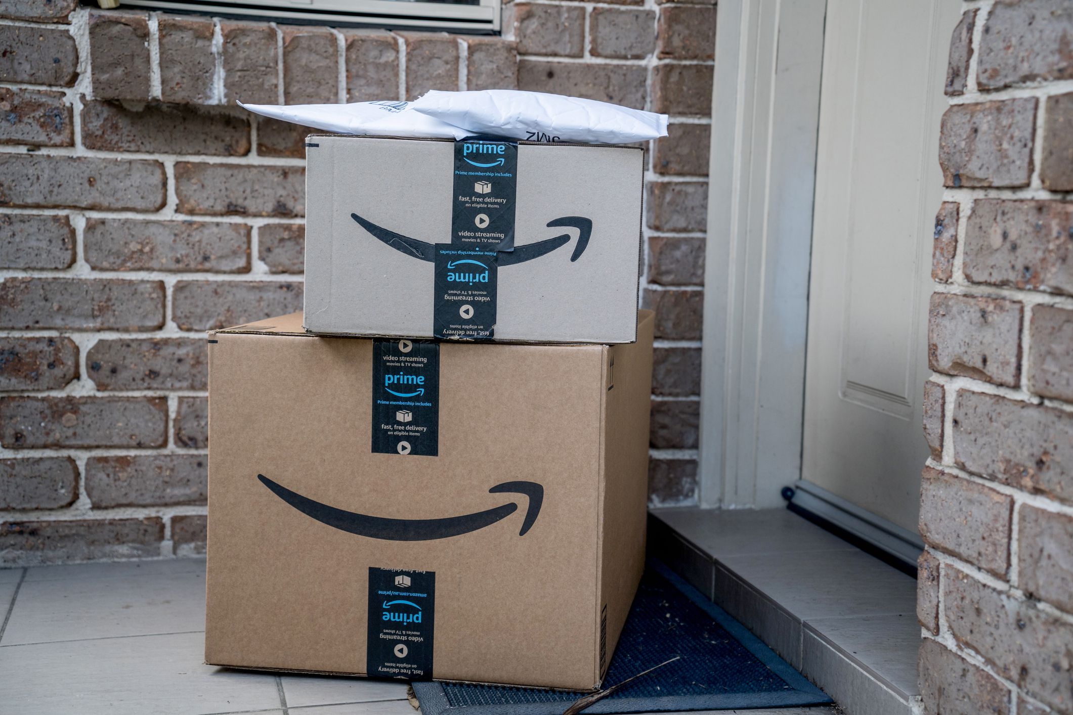 Sydney, Australia - 2022-07-22 Amazon prime boxes and envelopes delivered to a front door of residential building. Black Friday Cyber Monday Christmas Sale Prime Day. Amazon Flex delivery