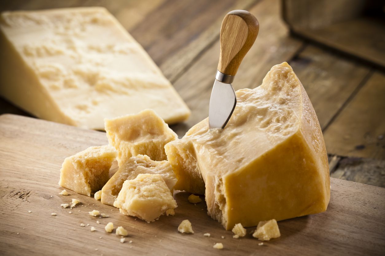 An image of different kinds of cheeses that have been placed on a cutting board.