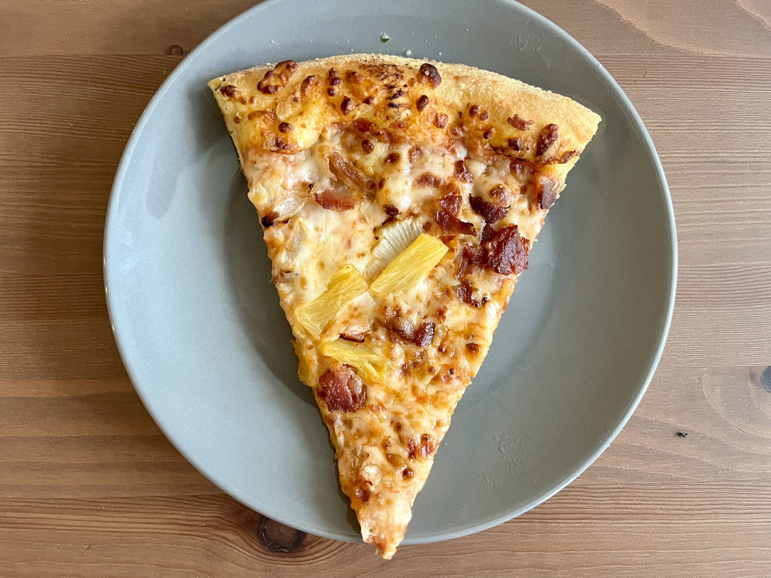 a slice of pizza reheated in the microwave
