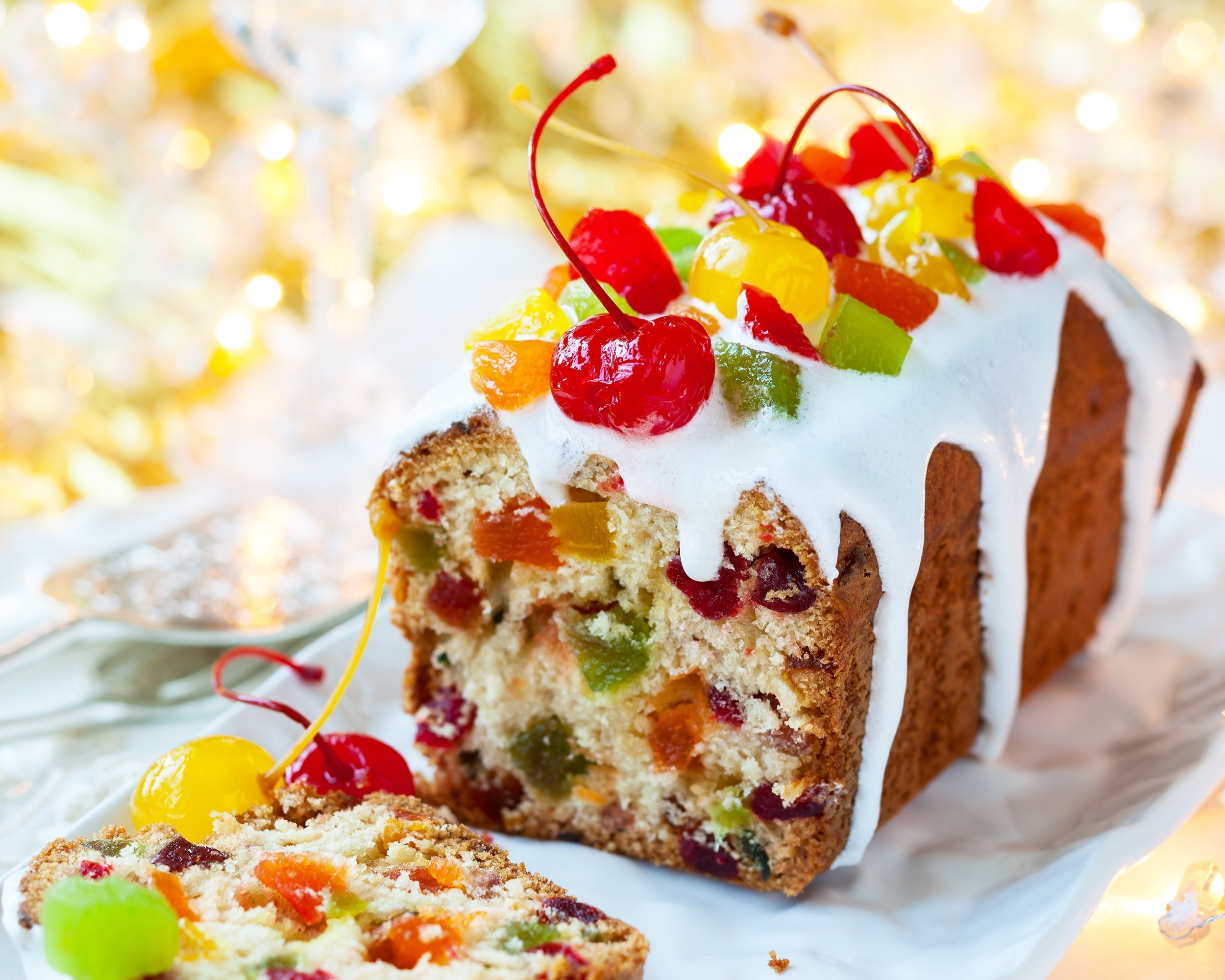 Christmas fruitcake with sugar icing and candied fruits