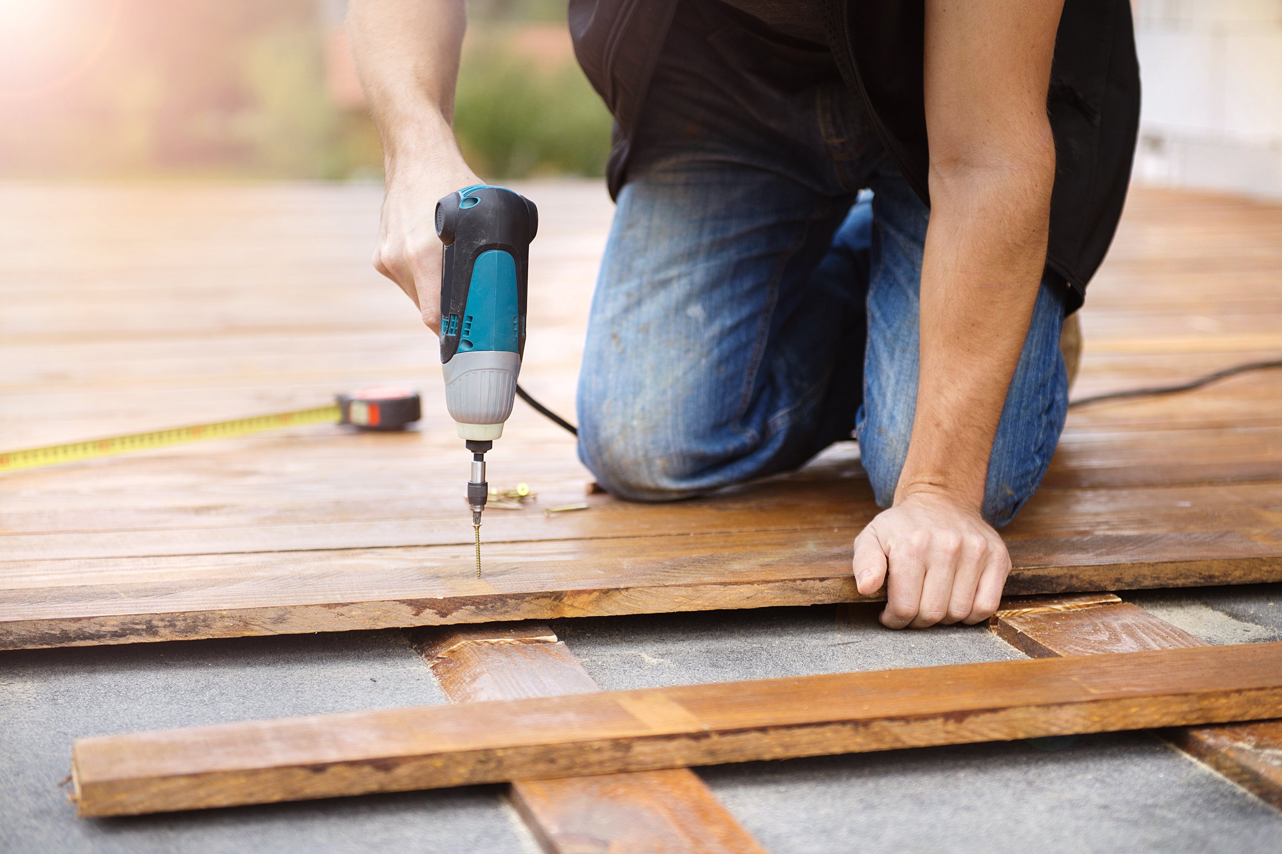 handyman installing wooden flooring